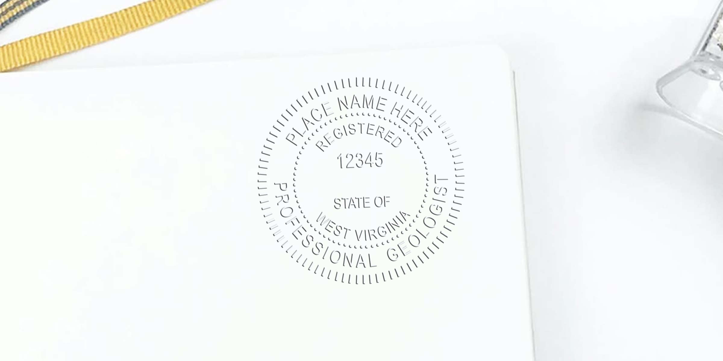 West Virginia geologist stamp embossed on white paper with gold ribbon and glass paperweight, showing geologist stamp rules.