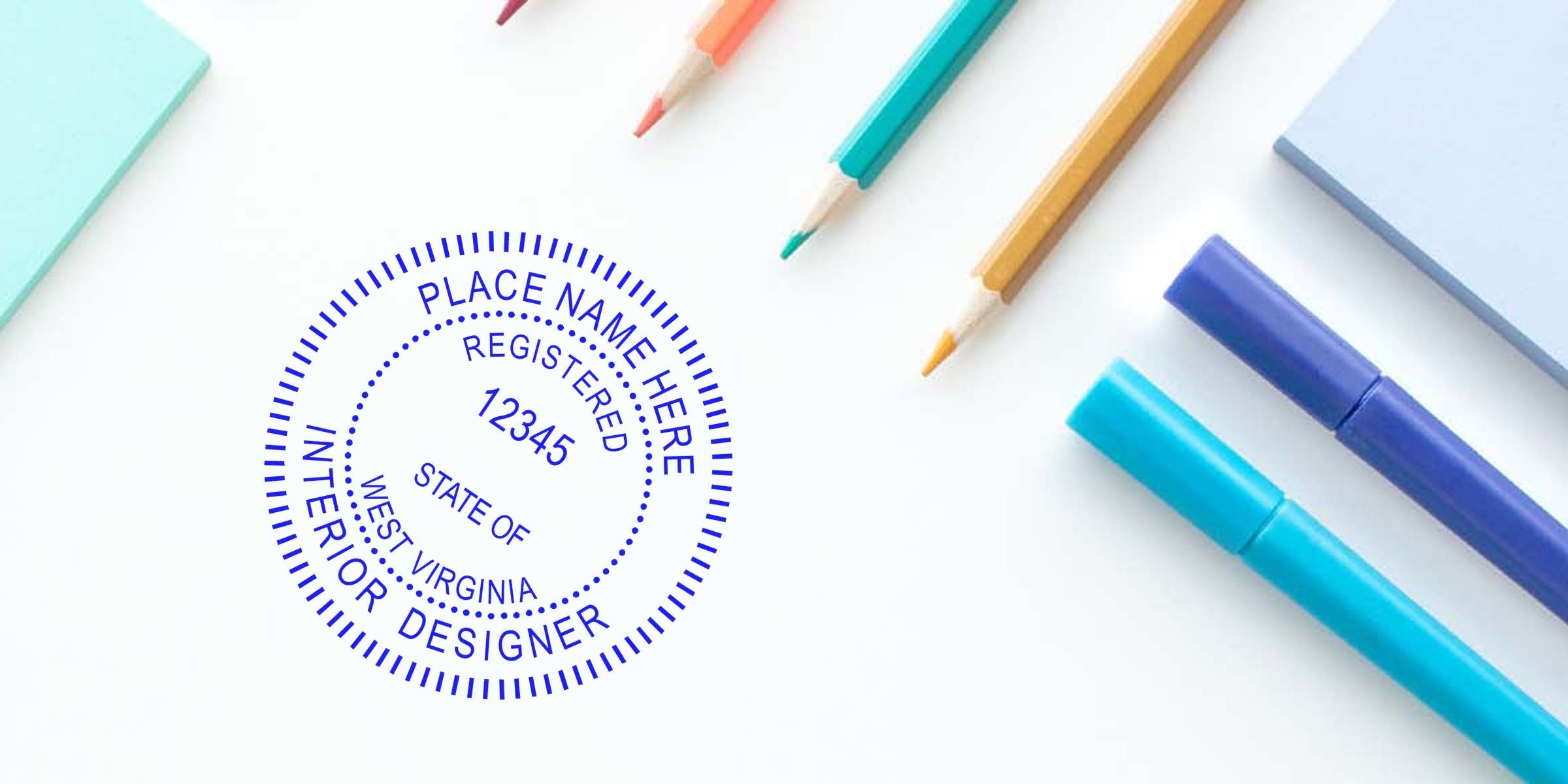 Custom interior designer stamp with colored pencils on white desk, highlighting Interior Designer Licensing WV and WV Interior Design Regulations for unique branding.