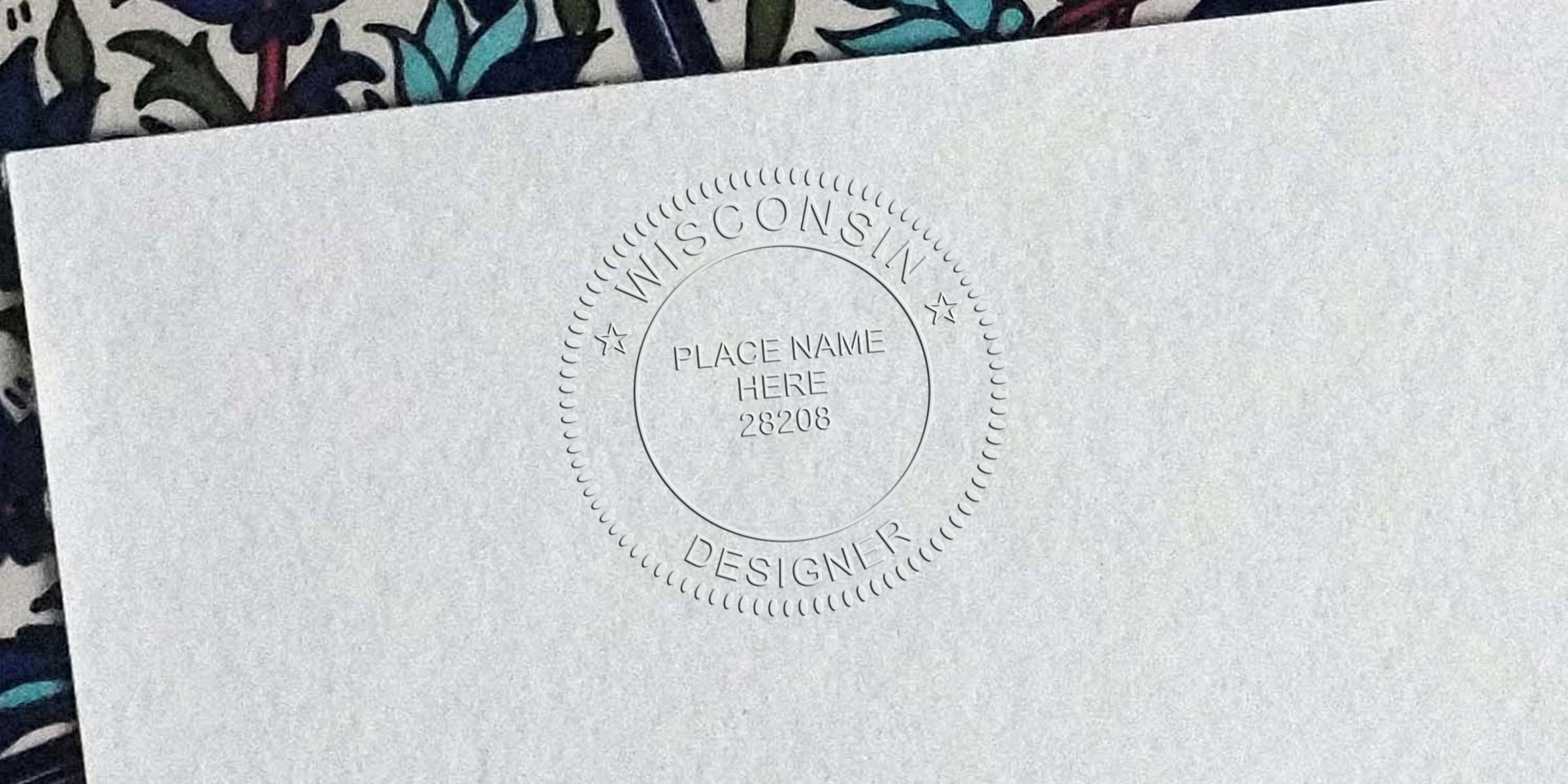 Embossed Wisconsin interior designer seal on white paper with a custom stamp showing professional design certification and location name.