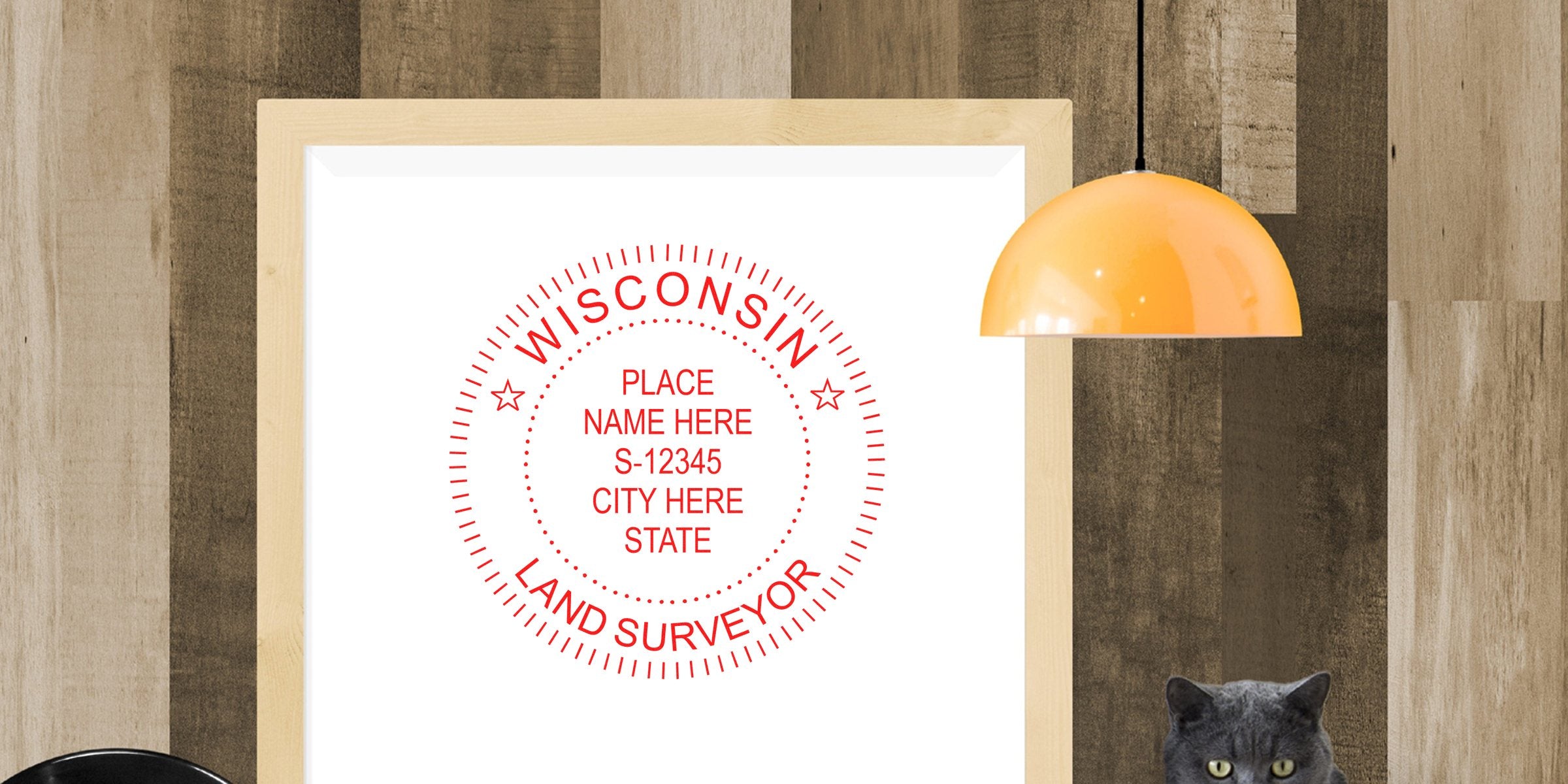 Wisconsin land surveyor seal framed on wooden wall, with modern orange pendant light and gray cat sitting nearby, highlighting the seal’s details.