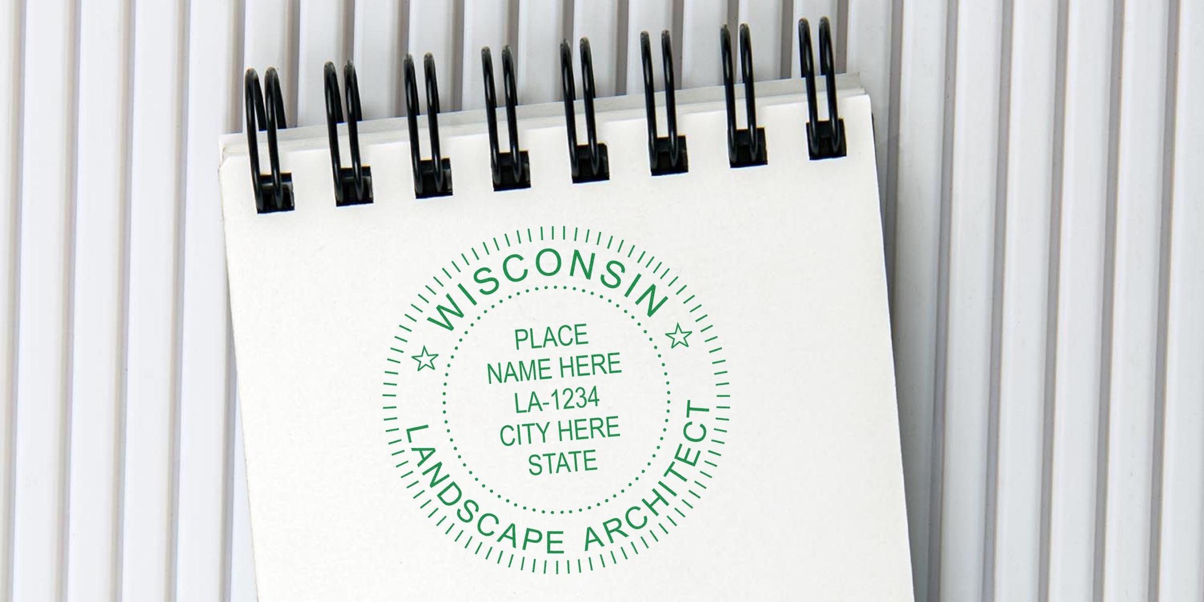 Spiral notebook with a stamp design of a Wisconsin landscape architect, including place name and city details.