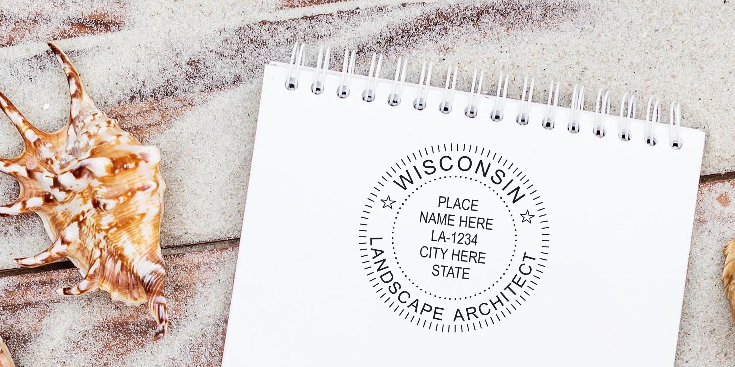 White spiral notebook with Wisconsin landscape architect stamp on a wooden beach table with seashells, showing the stamp order process.