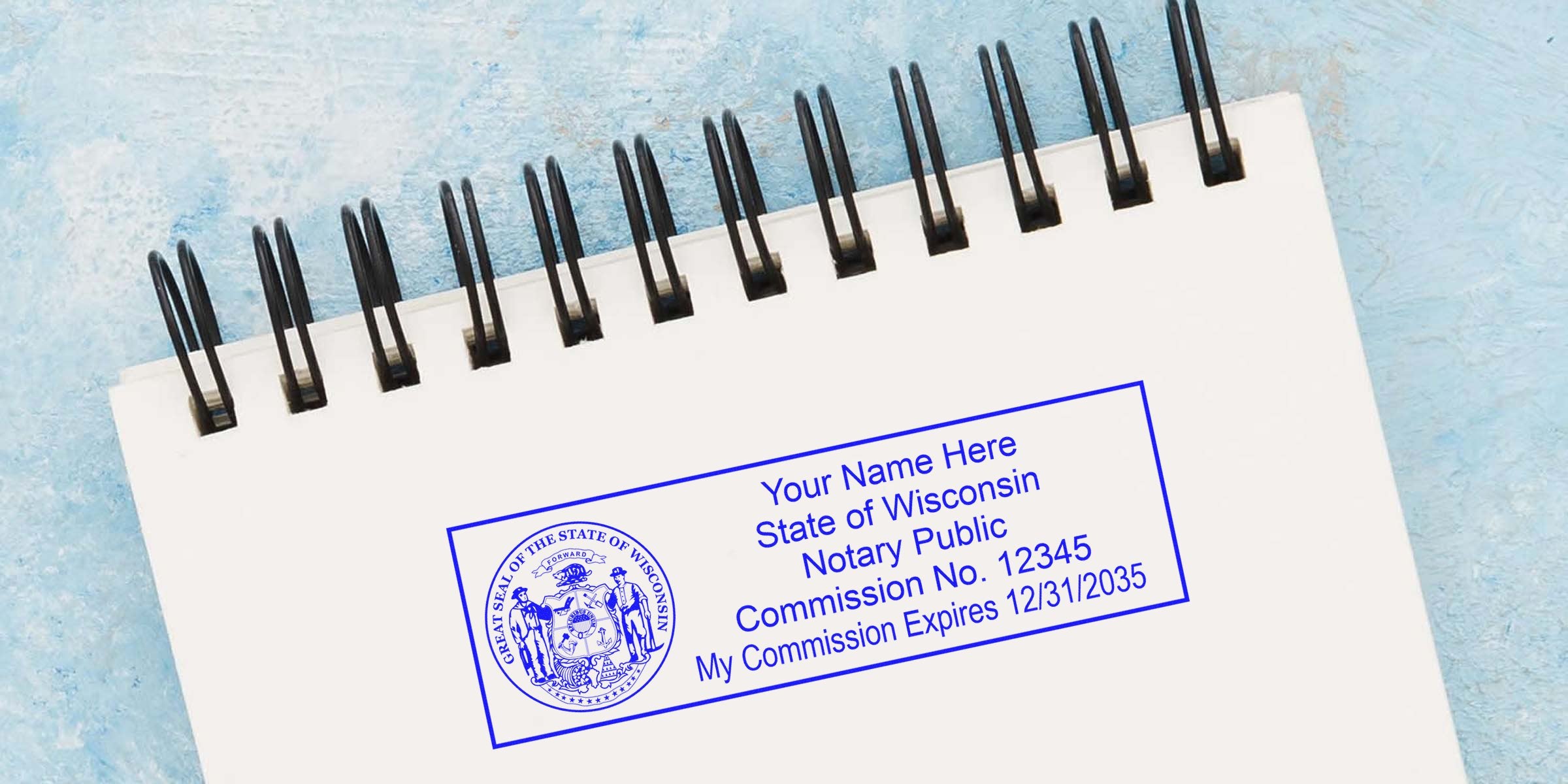 Wisconsin notary public stamp with commission number and seal expiration on a spiral notebook, highlighting Wisconsin notary seal renewal.