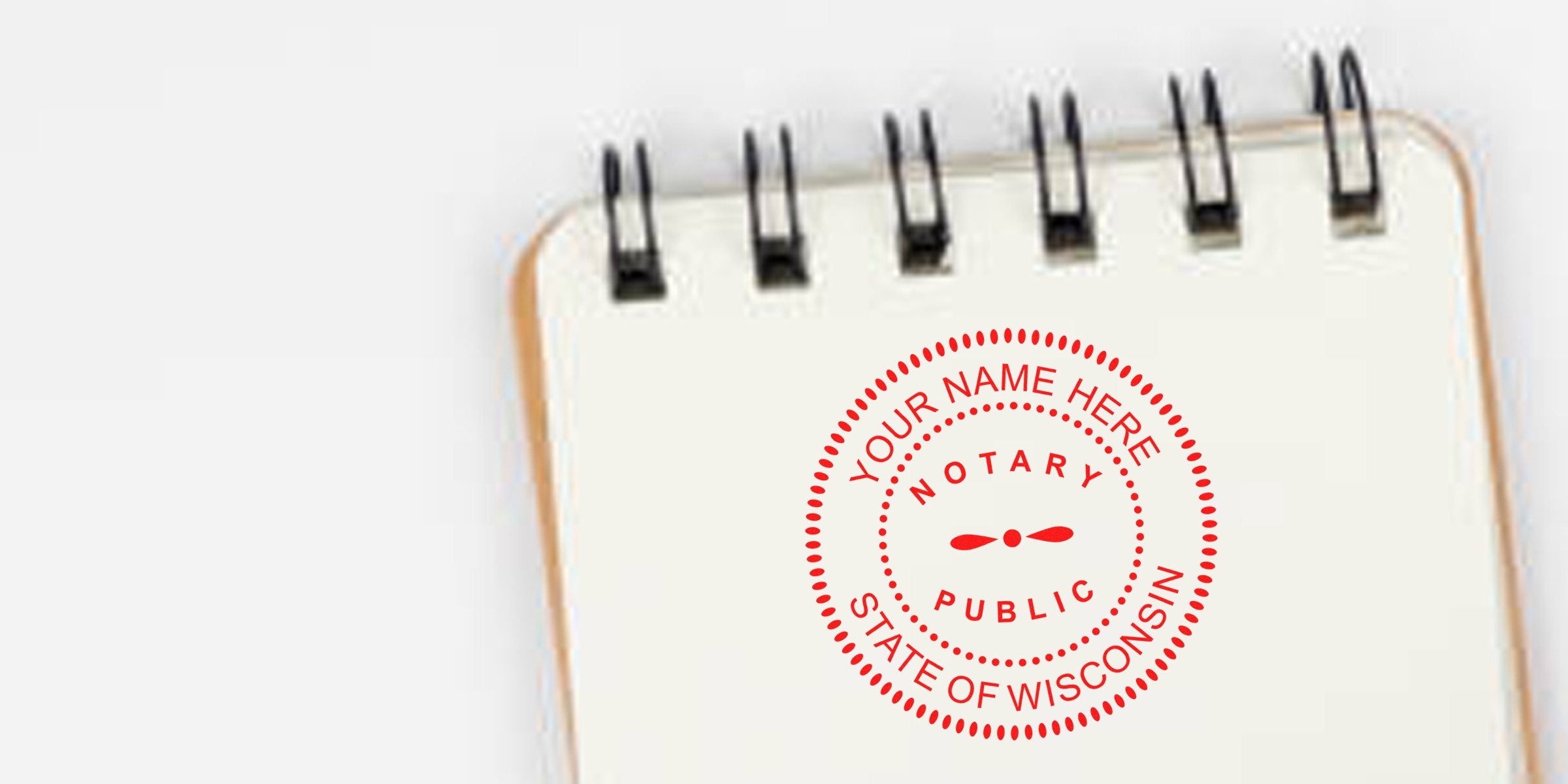 Wisconsin notary stamp on a spiral notebook with a self-inking stamp for Wisconsin notary services.