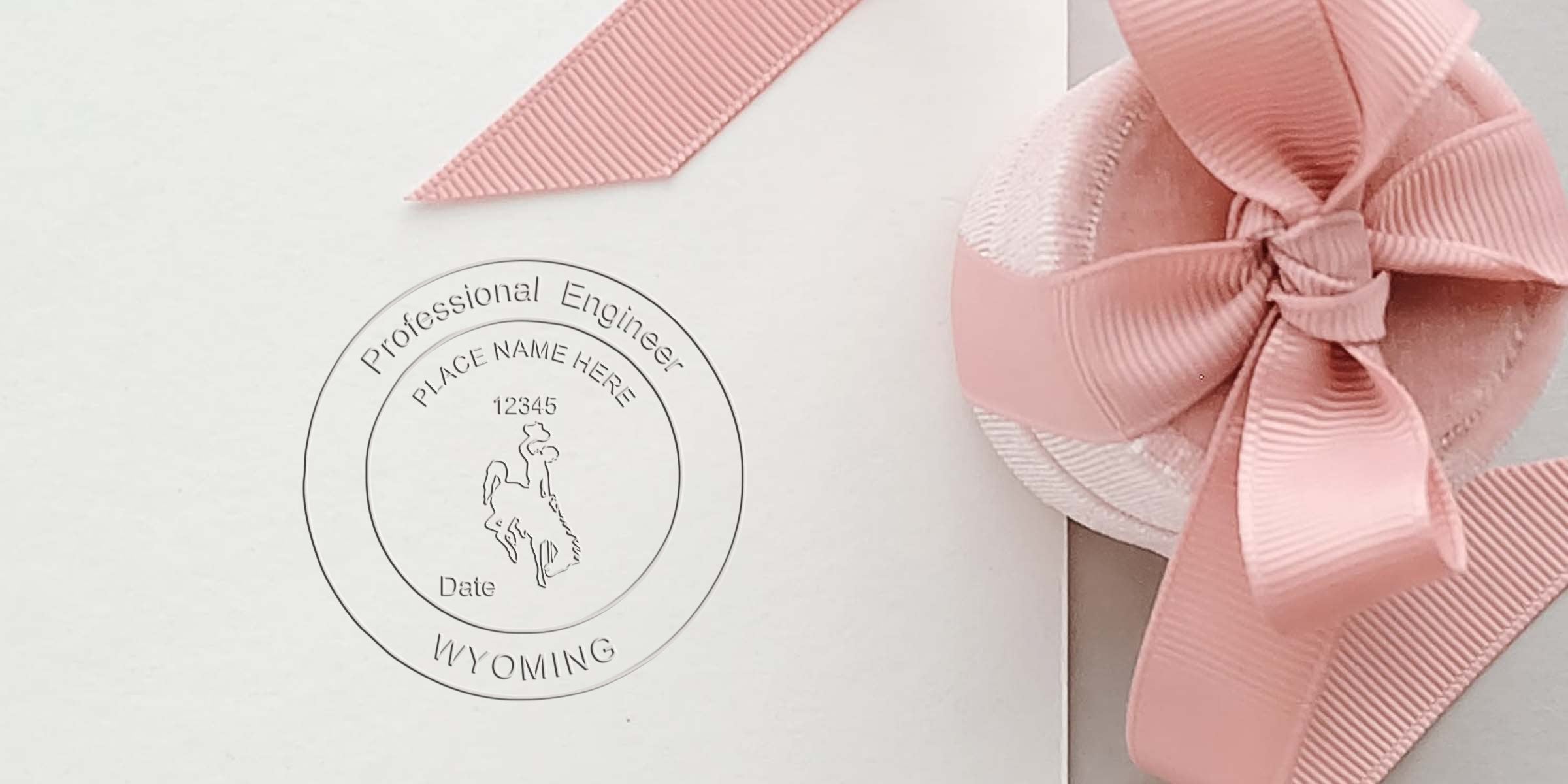 Embossed Wyoming Professional Engineer seal with pink ribbon on white paper, showing Wyoming PE Seal requirements for Professional Engineer licensing.