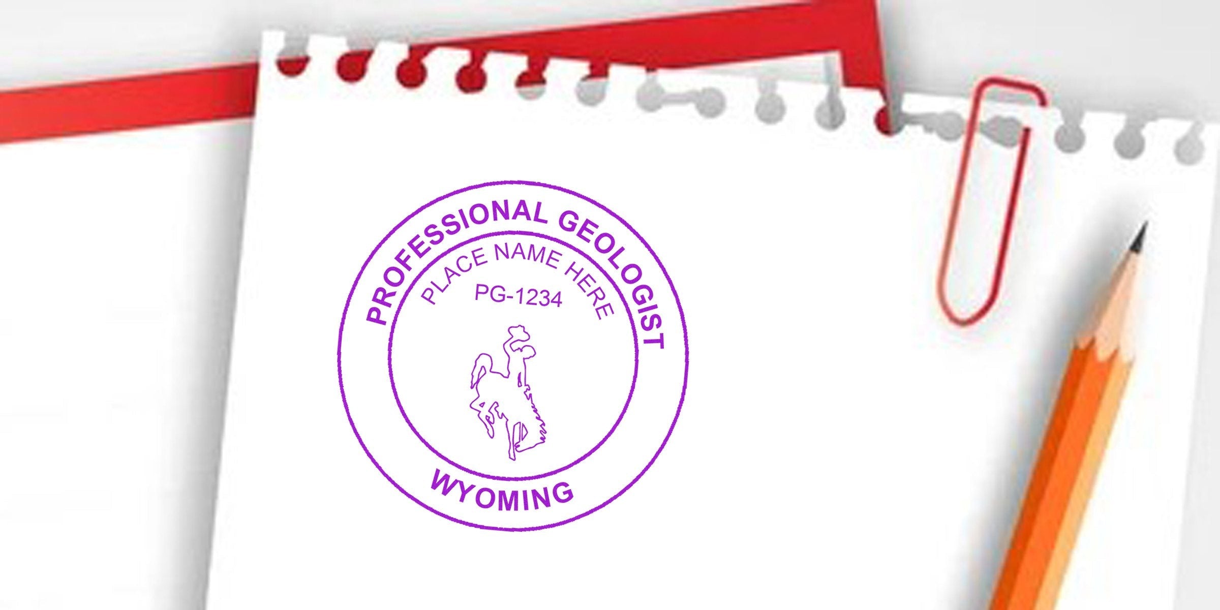Wyoming geologist stamp with pencil and paperclip on white notepad displaying a custom seal for geology certification.