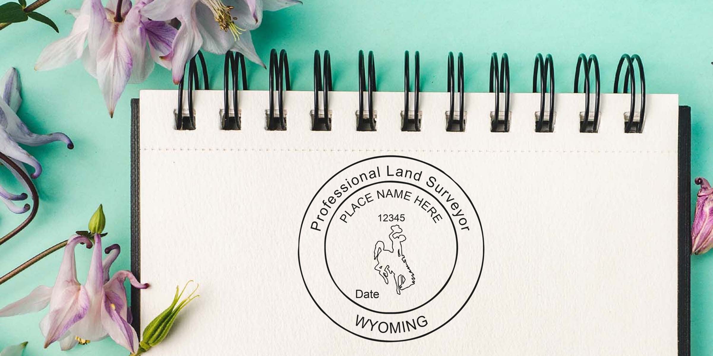 Wyoming land surveyor seal stamped on a notebook with a floral background, highlighting the professional land surveyor seal design.