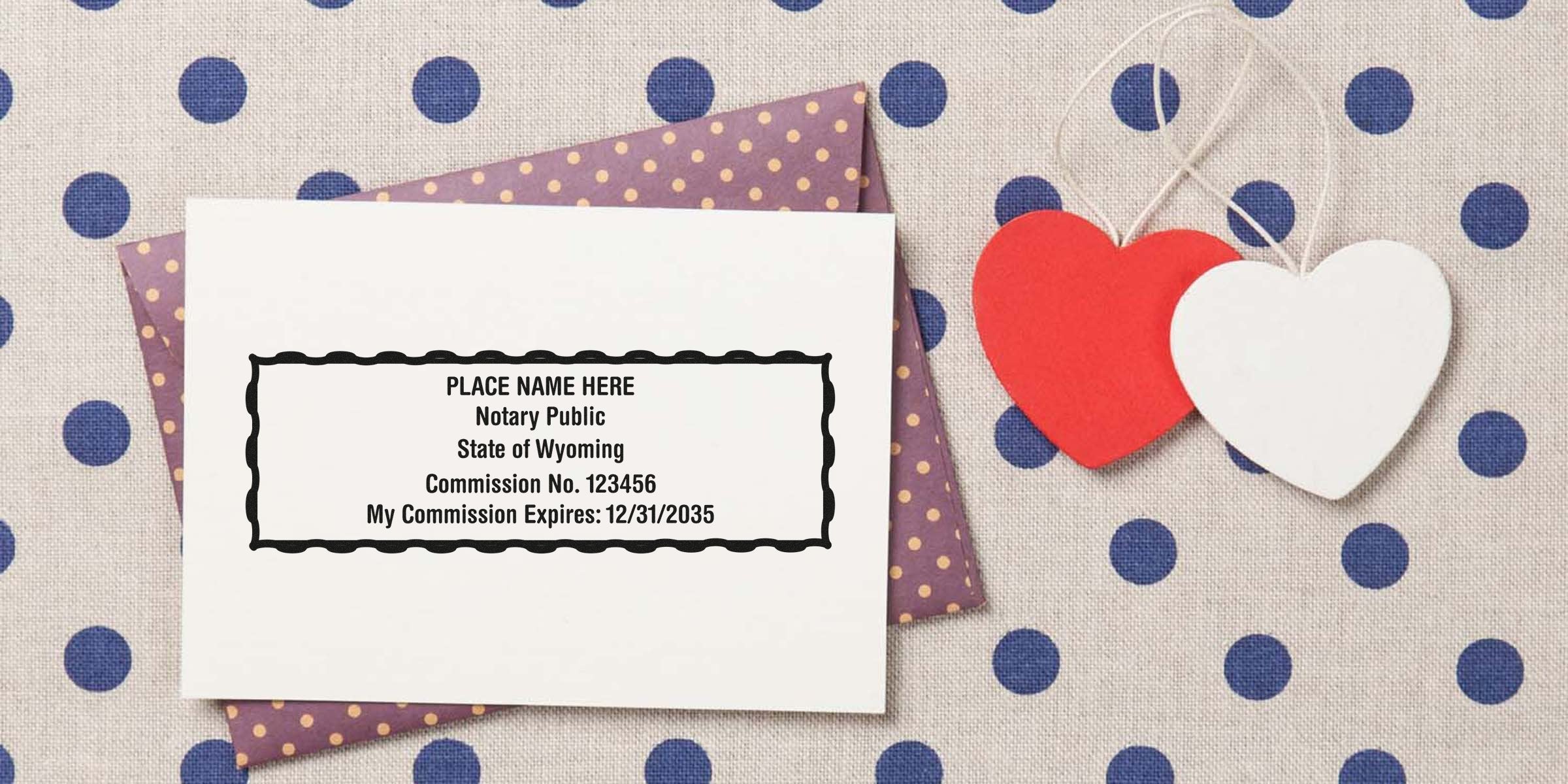 Wyoming notary public stamp with commission number and expiration date on white card, alongside purple polka dot envelope and red-white heart tags, showcasing essential WY notary supplies and tools.