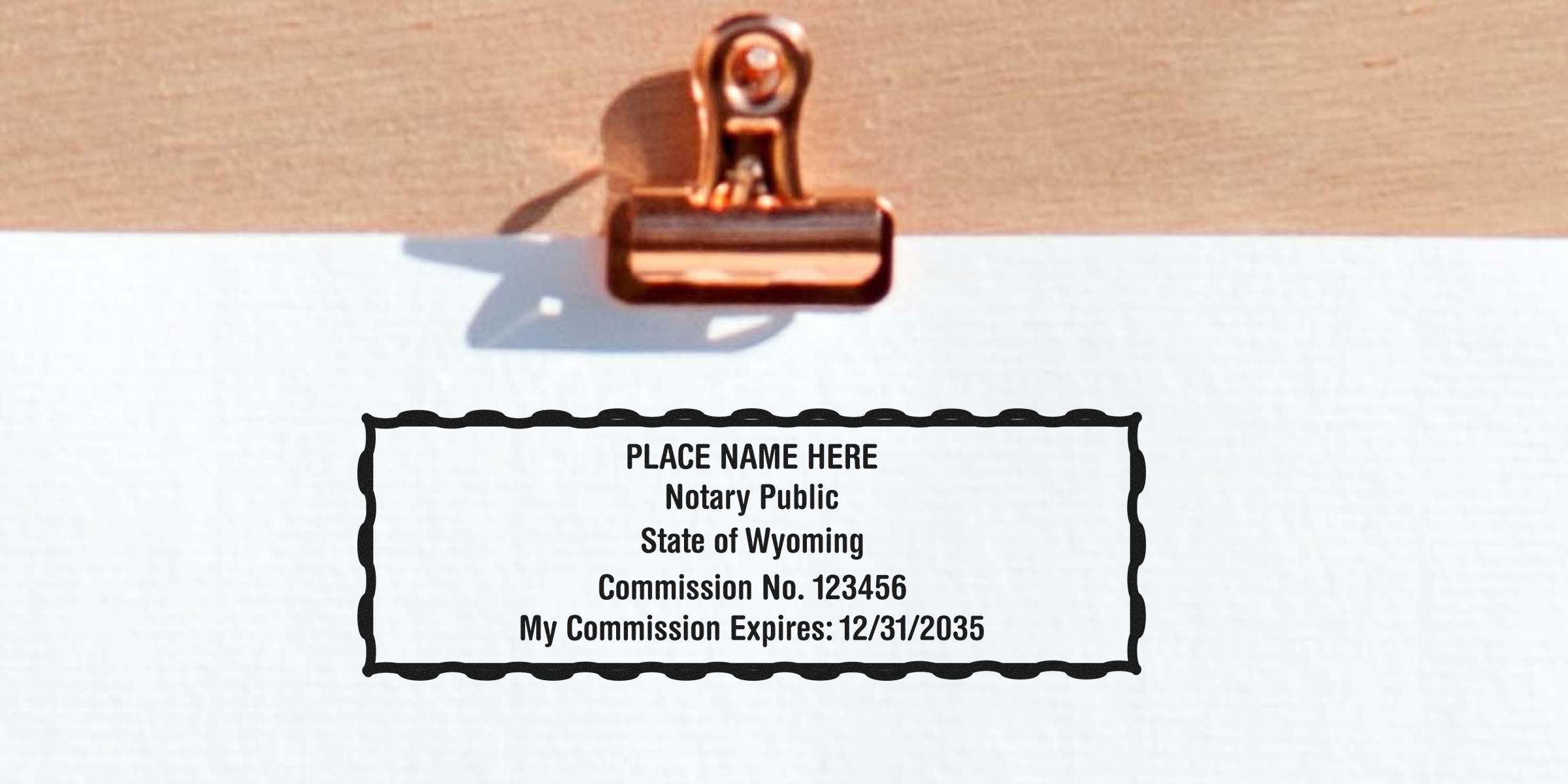 Wyoming notary stamp security on commission certificate with expiration date, copper paper clip, featuring online notary stamp protection.