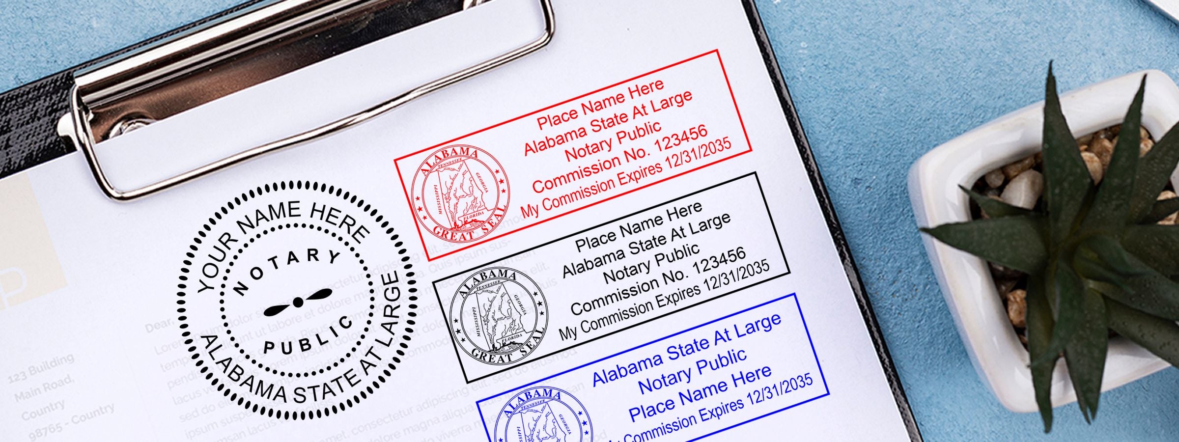 Clipboard showing sample Alabama notary public stamp designs in red, black, and blue beside a succulent; Alabama Notary Supplies, Stamps and Seals.
