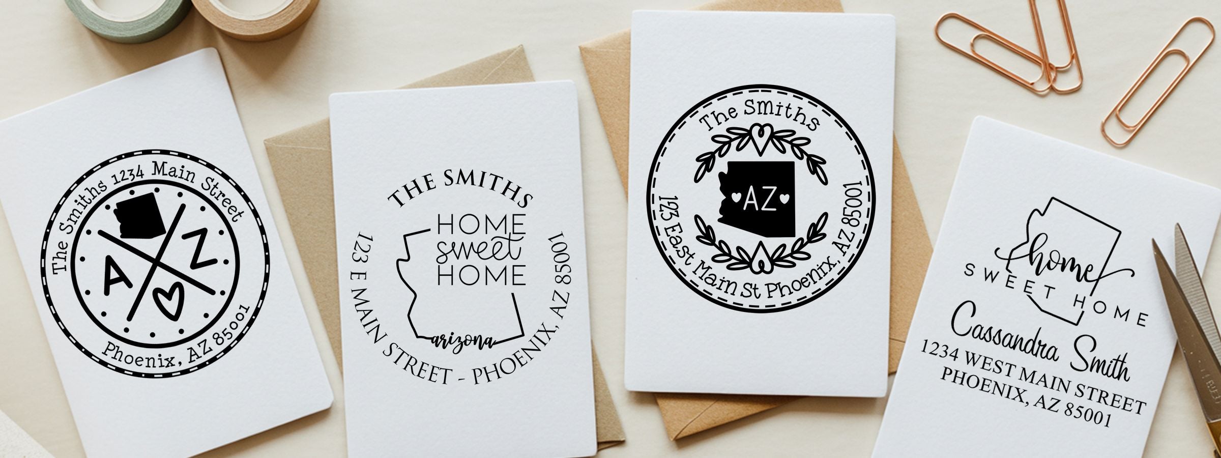Four personalized greeting cards with Arizona monograms and home designs by Arizona Designer Stamps and Seals on a light desk.