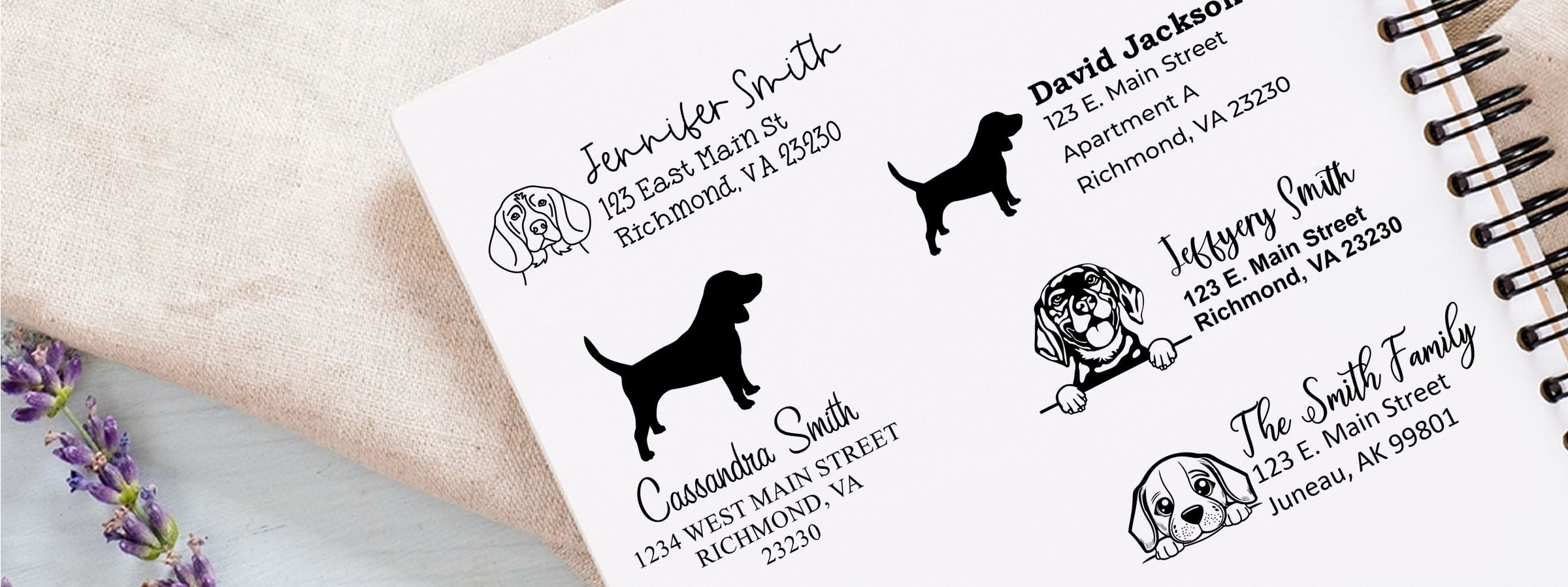 Notebook page of custom pet return-address labels with dog art and sample names on a spiral pad beside fabric and lavender; Beagle Dog Stamps and Custom Seals