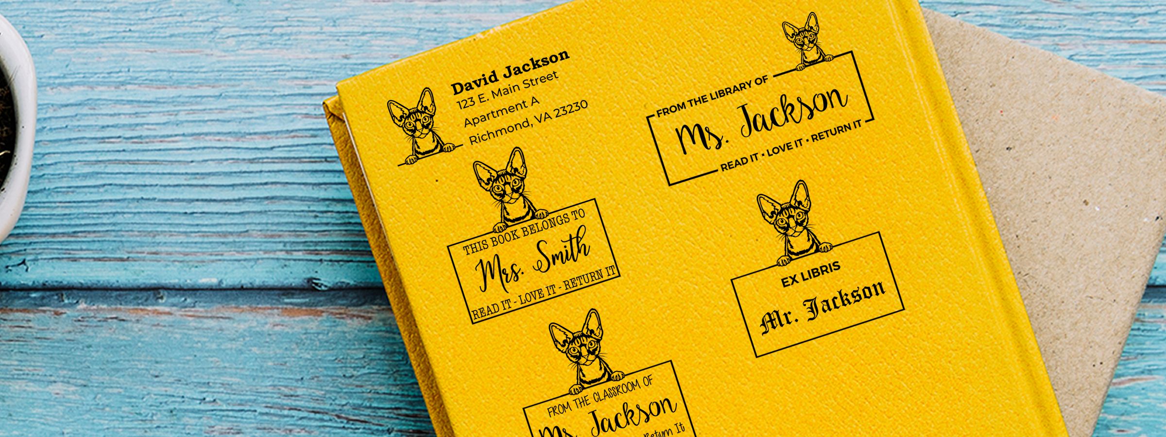 Yellow book cover on blue wood with Devon Rex Cat Stamps and Custom Seals for Mrs. Jackson, Mrs. Smith, and Mr. Jackson, with tan envelope.