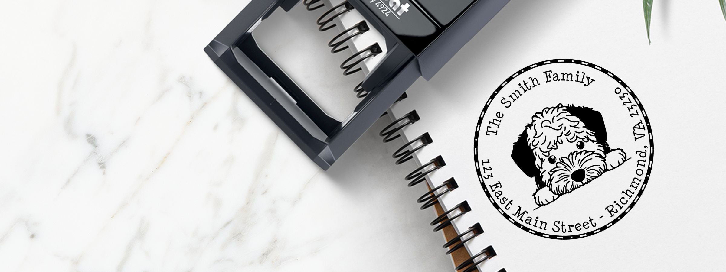 Black custom stamp on a spiral notebook beside a fluffy dog logo for Lagotto Romagnolo Dog Stamps and Custom Seals, The Smith Family.