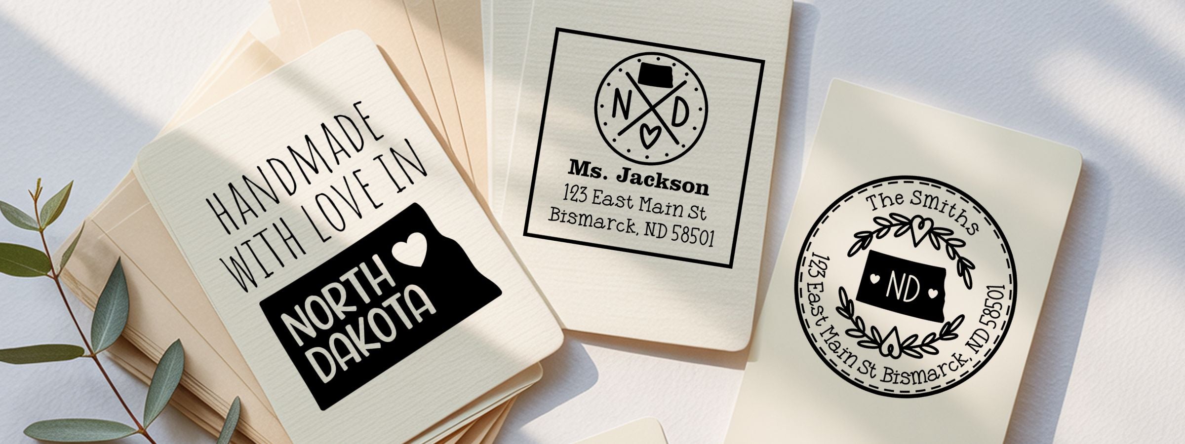 Three personalized North Dakota Designer Stamps and Seals cards with black-and-cream designs, Handmade with Love, Ms. Jackson, and The Smiths.