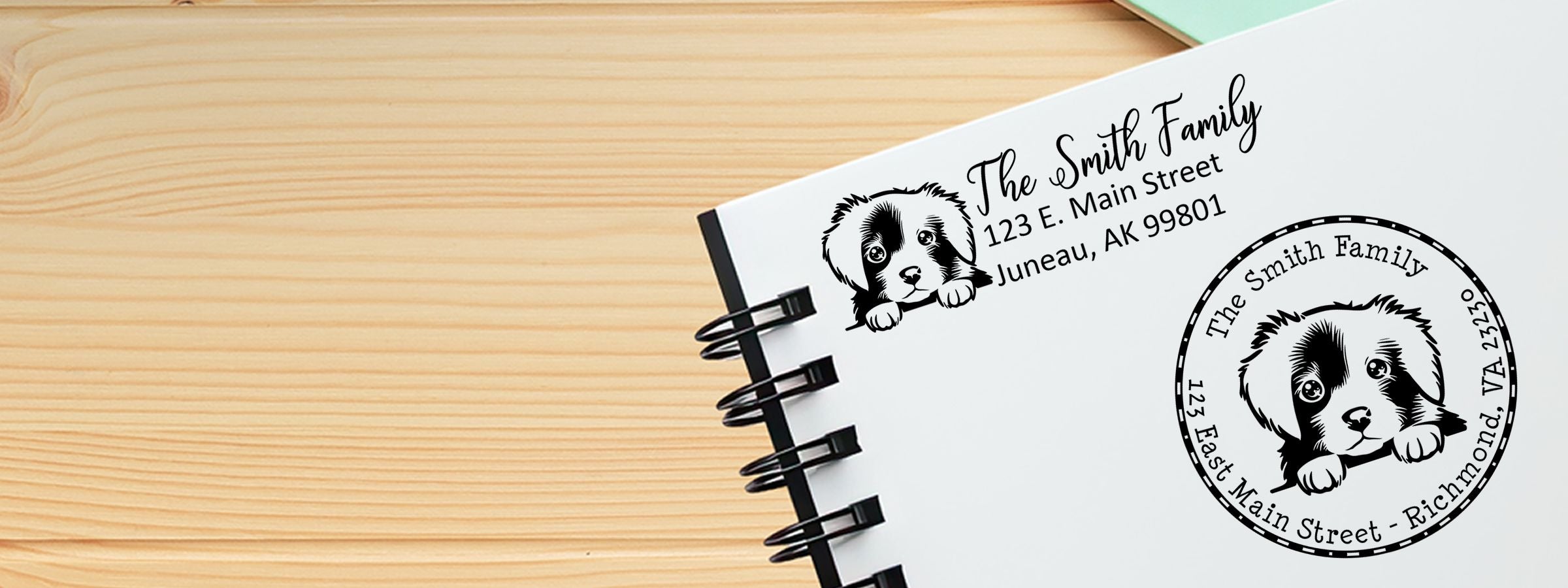 White spiral notebook on light wood with The Smith Family dog logo and address, featuring Nova Scotia Duck Tolling Retriever Dog Stamps and Custom Seals.