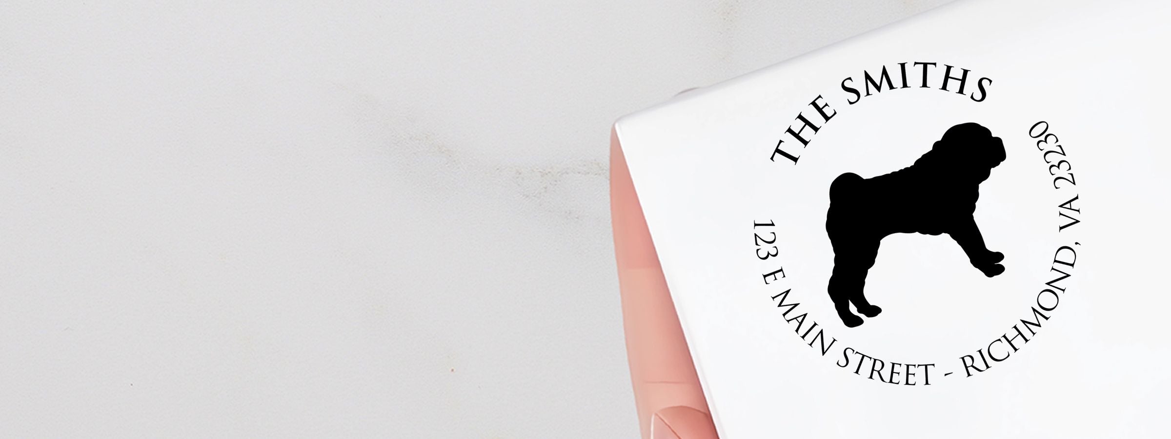 White folded box with black dog silhouette logo and circular address text, featuring Shar Pei Dog Stamps and Custom Seals.