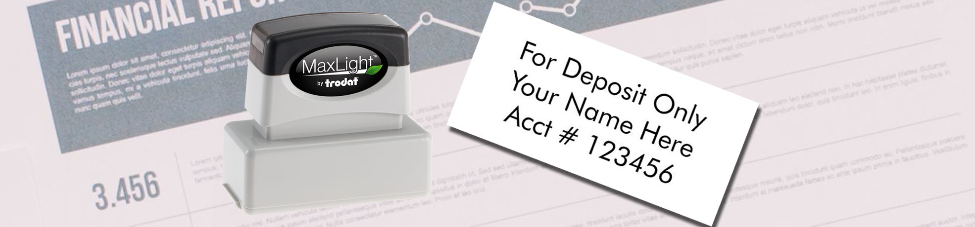 Endorsement Stamps self-inking MaxLight with tilted “For Deposit Only” deposit imprint over financial report.