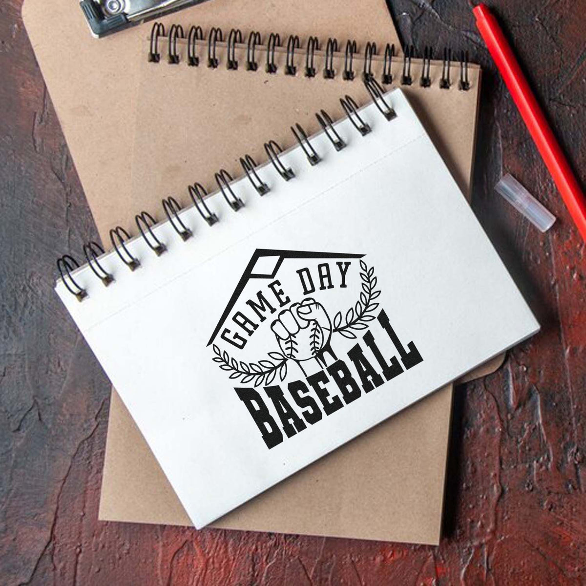 Vintage Pro Game Day Baseball Fist Premium Wooden Stamp imprint stamped in black ink. A fist holding a baseball sits between leafy branches inside a home plate frame labeled "Game day baseball."