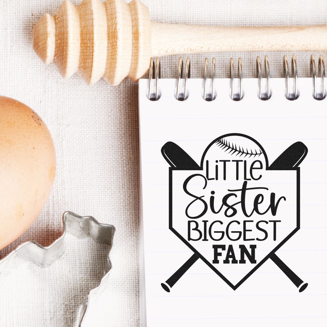Baseball-themed rubber stamp design reading Little Sister Biggest Fan on a notepad with sports props.