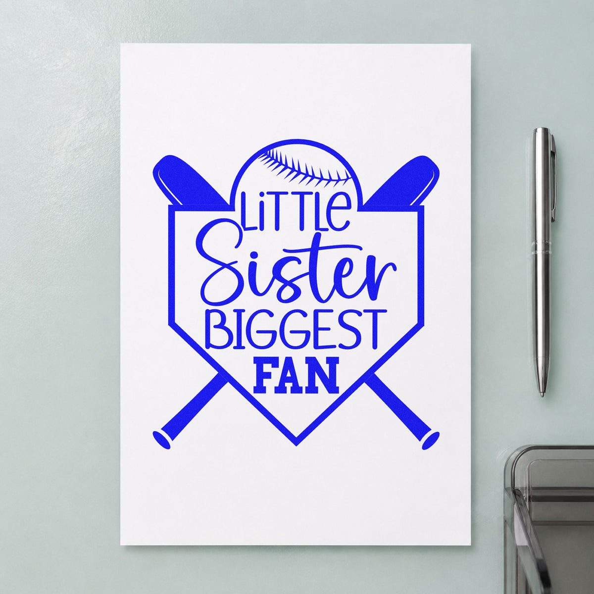 Little Sister Biggest Fan craft stamp imprinted in blue ink on paper, a design suited to hair bow gift cards.