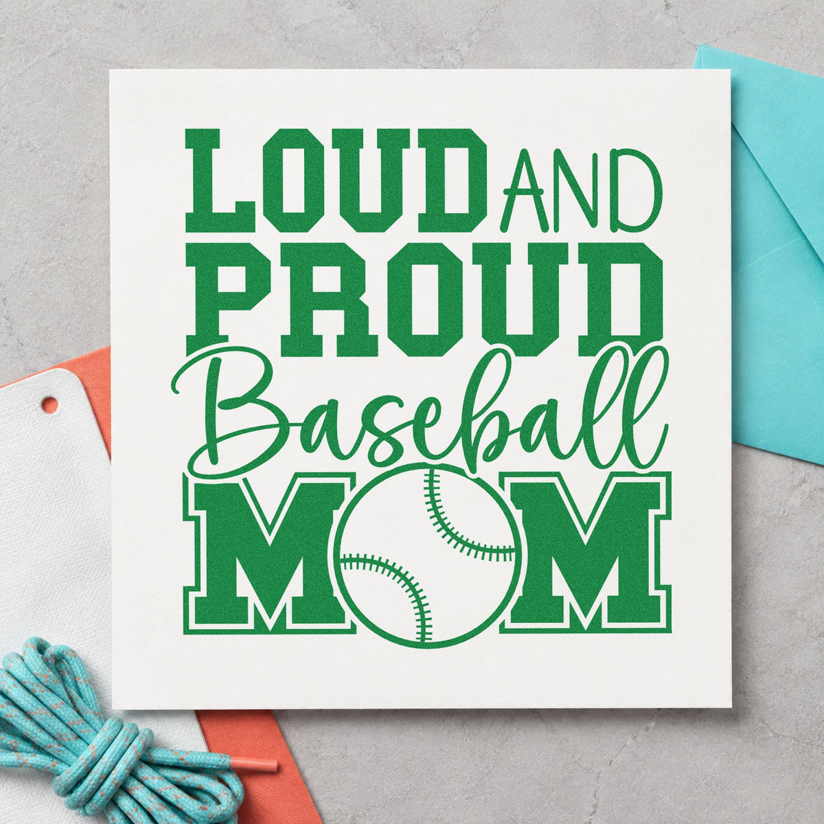 Loud and Proud Baseball Mom craft stamp imprint in green ink on a handmade project, one idea being fundraiser bake sale tags.