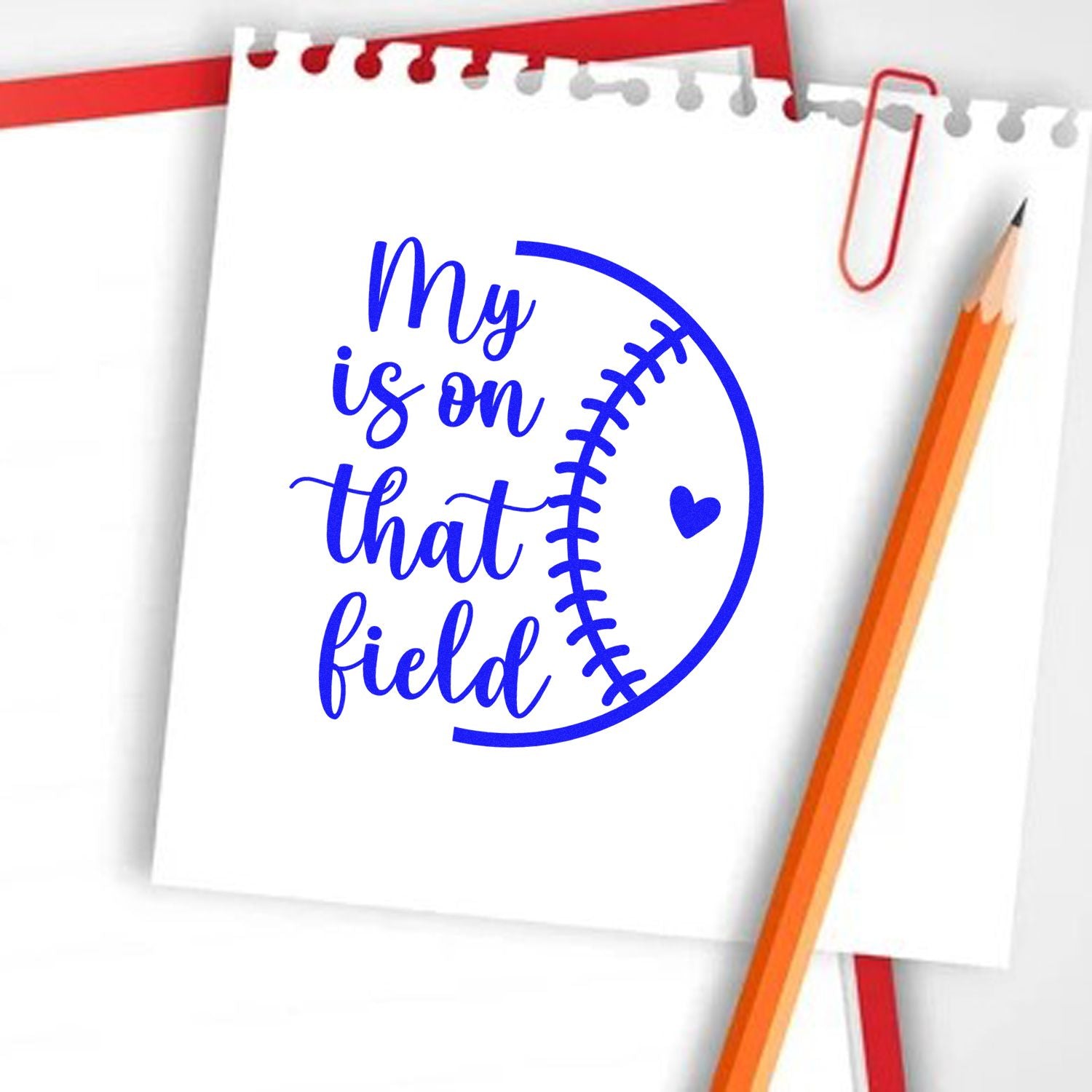 Baseball-themed rubber stamp design with notebook paper, pencil, and heart graphic reading My heart is on that field.
