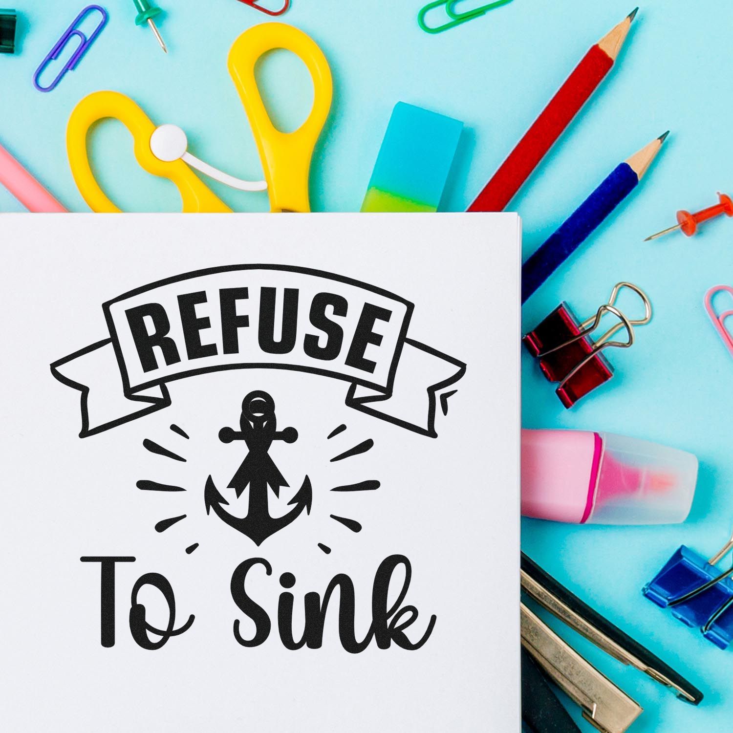 Refuse to Sink anchor rubber stamp design on paper with colorful school supplies for motivational crafting.