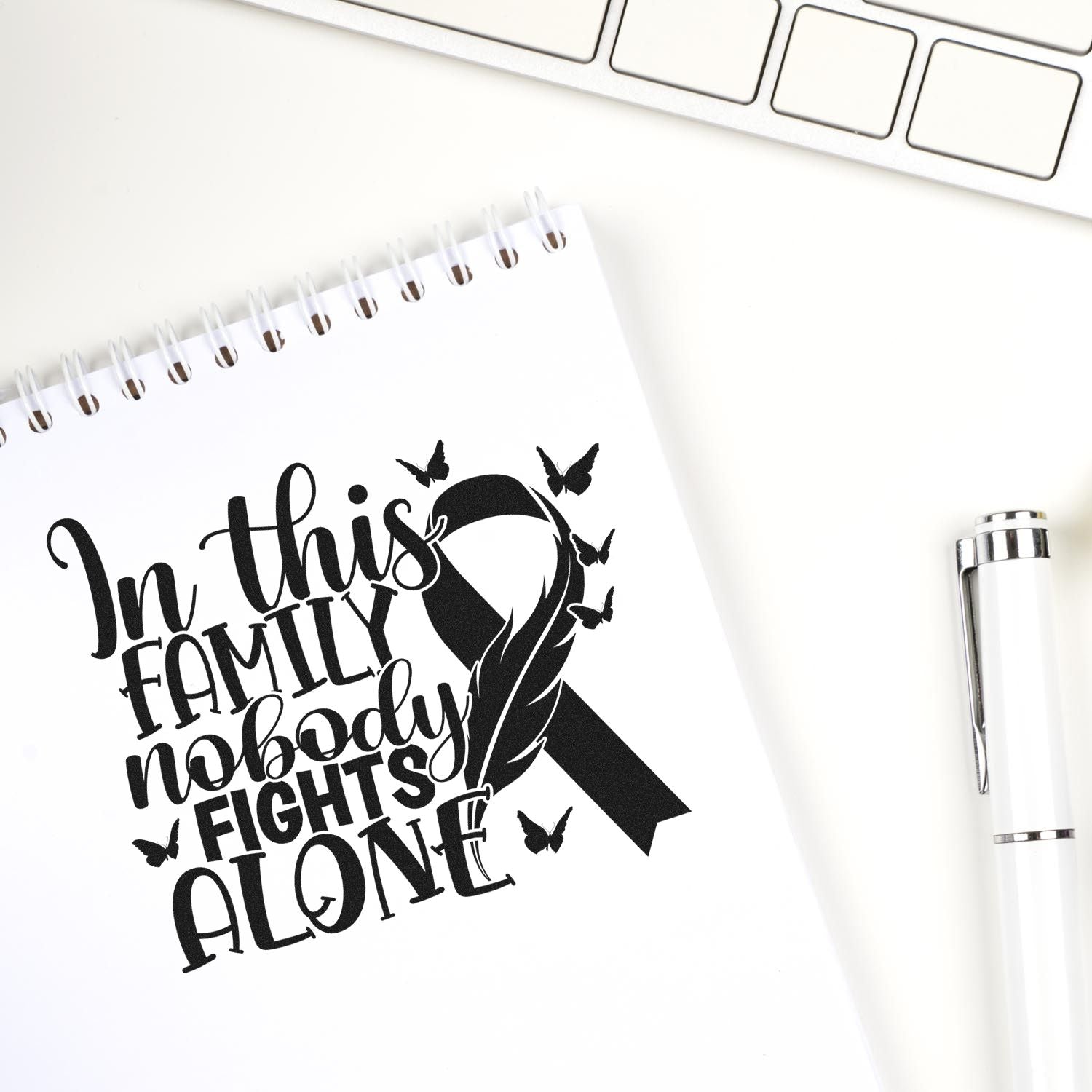 Custom rubber stamp design reading In this family nobody fights alone with black ribbon and butterflies for cancer support.