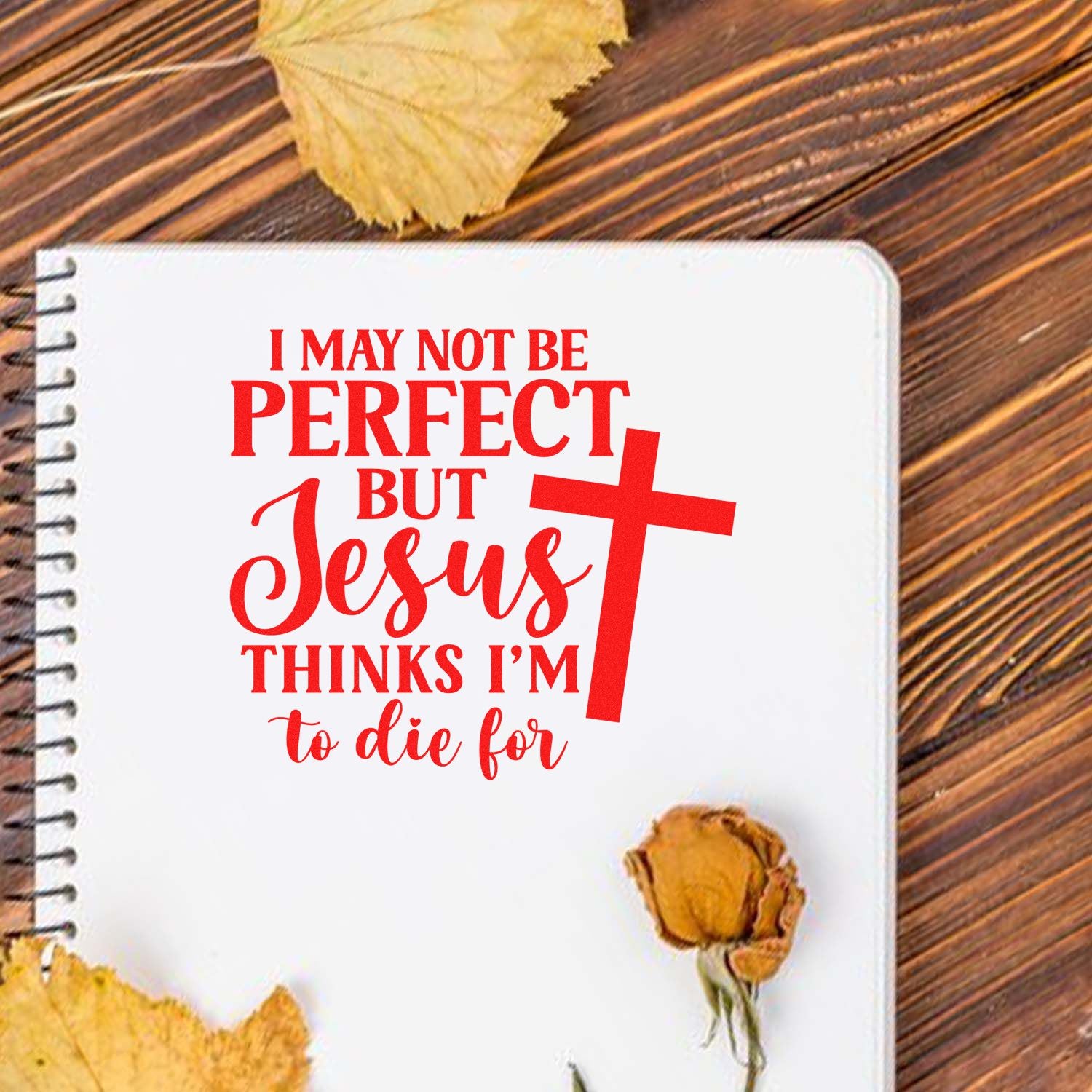 Faith-based rubber stamp design with quote I may not be perfect but Jesus thinks Im to die for on a notebook.