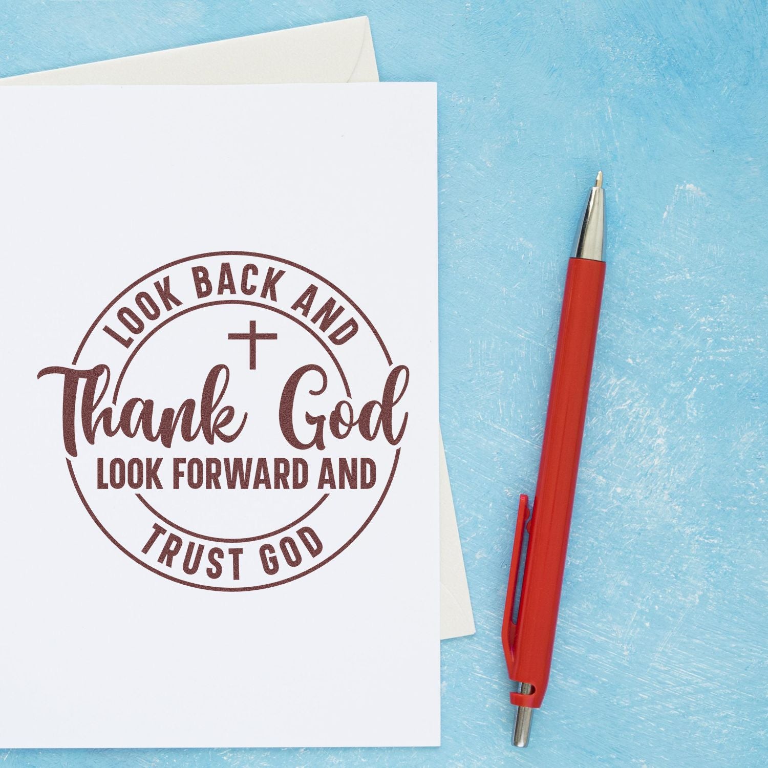Christian rubber stamp quote with cross: Look back and thank God, look forward and trust God on white paper.