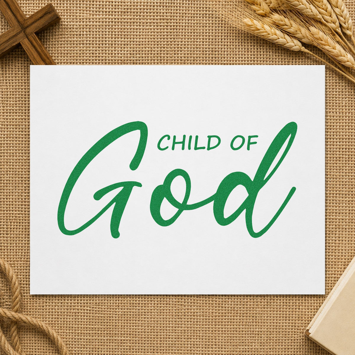 Child of God Script craft stamp imprint in green ink on a handmade project, one idea being onesie stamping.