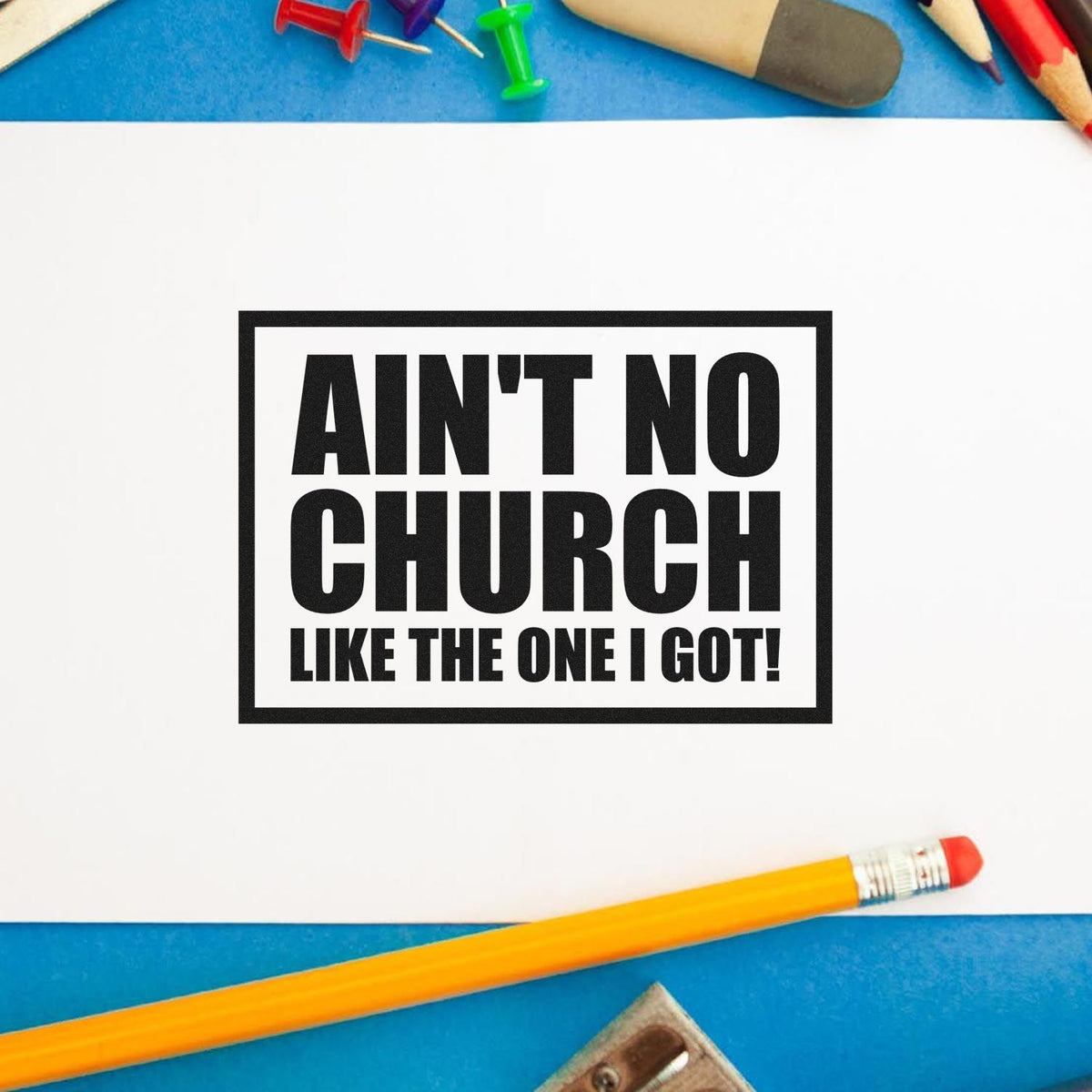 Ain't No Church Like The One I Got Premium Wood-Mounted Stamp - Vintage Pro imprint stamped in black ink. A rectangular outline encloses bold stacked "Ain't no church like the one I got" lettering.