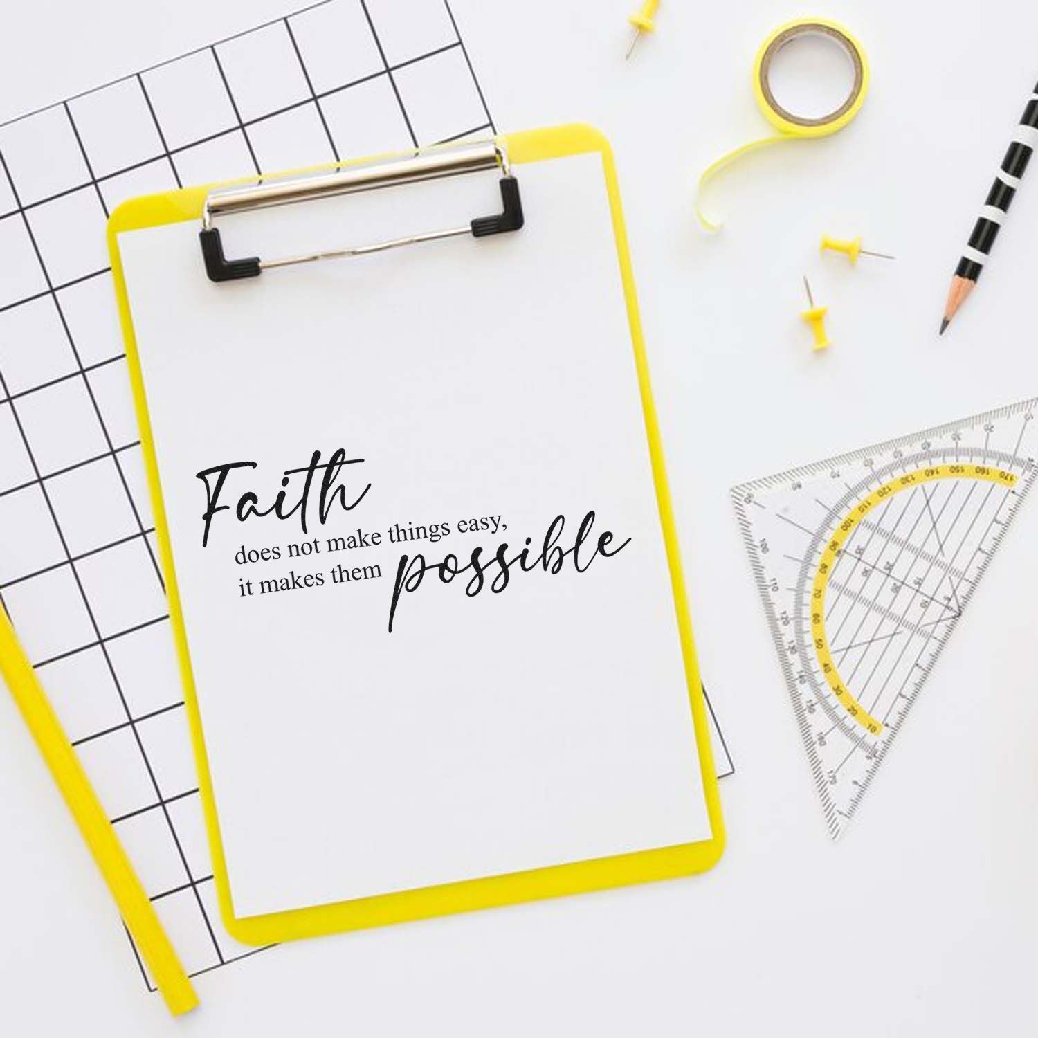 Faith quote rubber stamp design on clipboard with school supplies: Faith does not make things easy, it makes them possible.