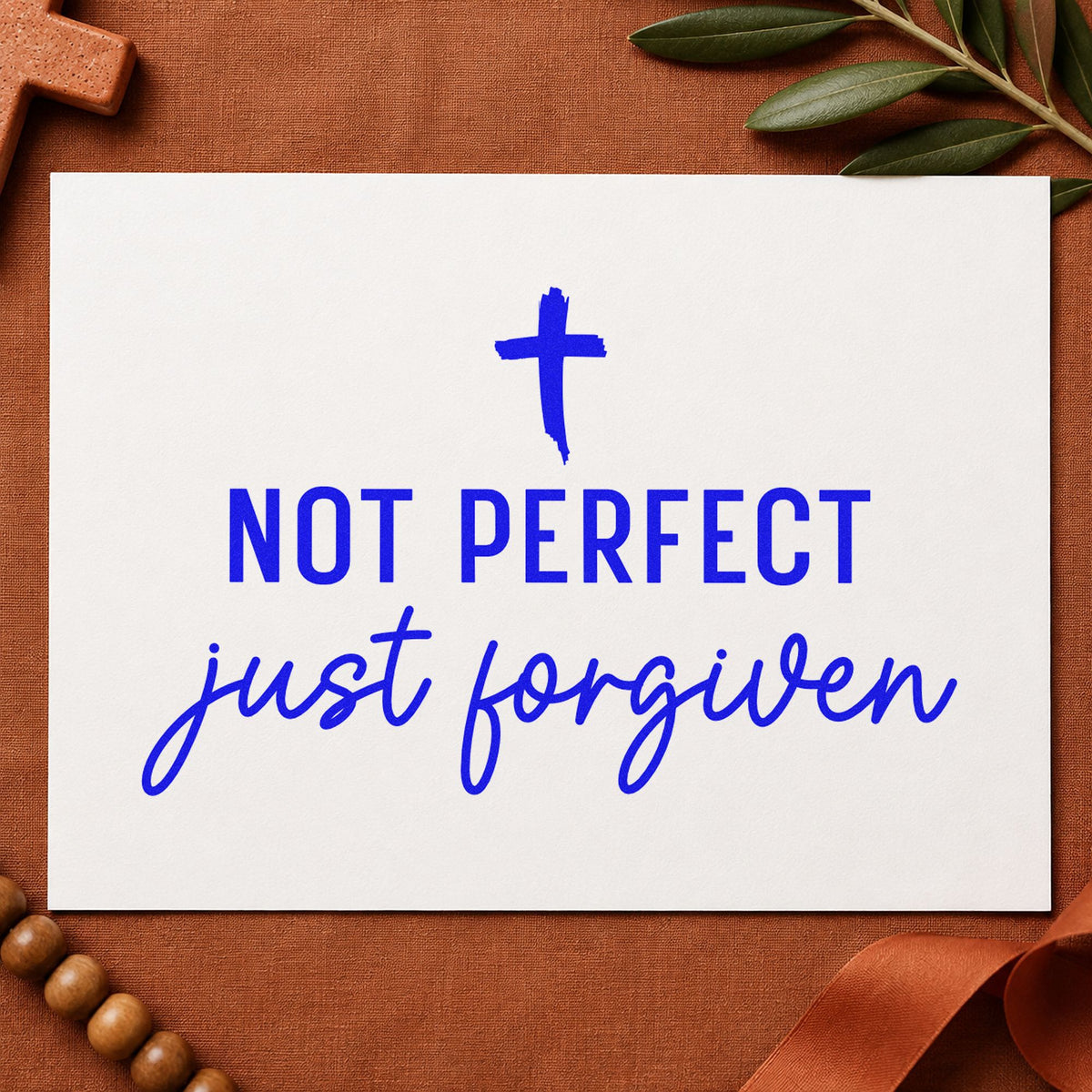 Not Perfect Forgiven Cross craft stamp imprinted in blue ink on paper, a design suited to journal cover stamping.