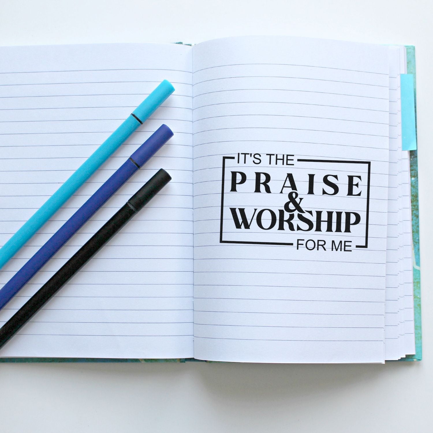 Custom praise and worship rubber stamp on a notebook page with pens, perfect for faith journaling and planners.