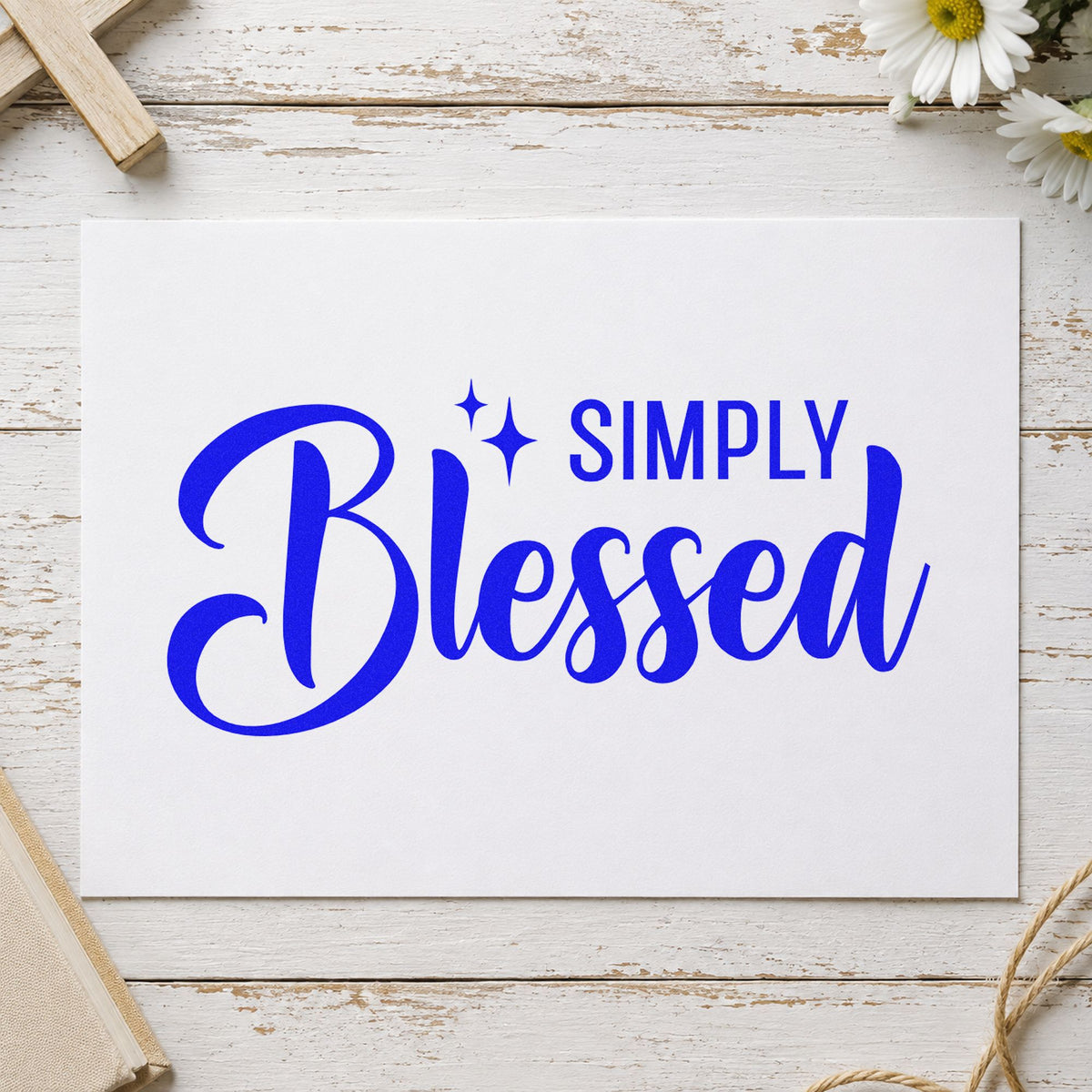 Simply Blessed craft stamp imprinted in blue ink on paper, a design suited to gift wrap pattern.