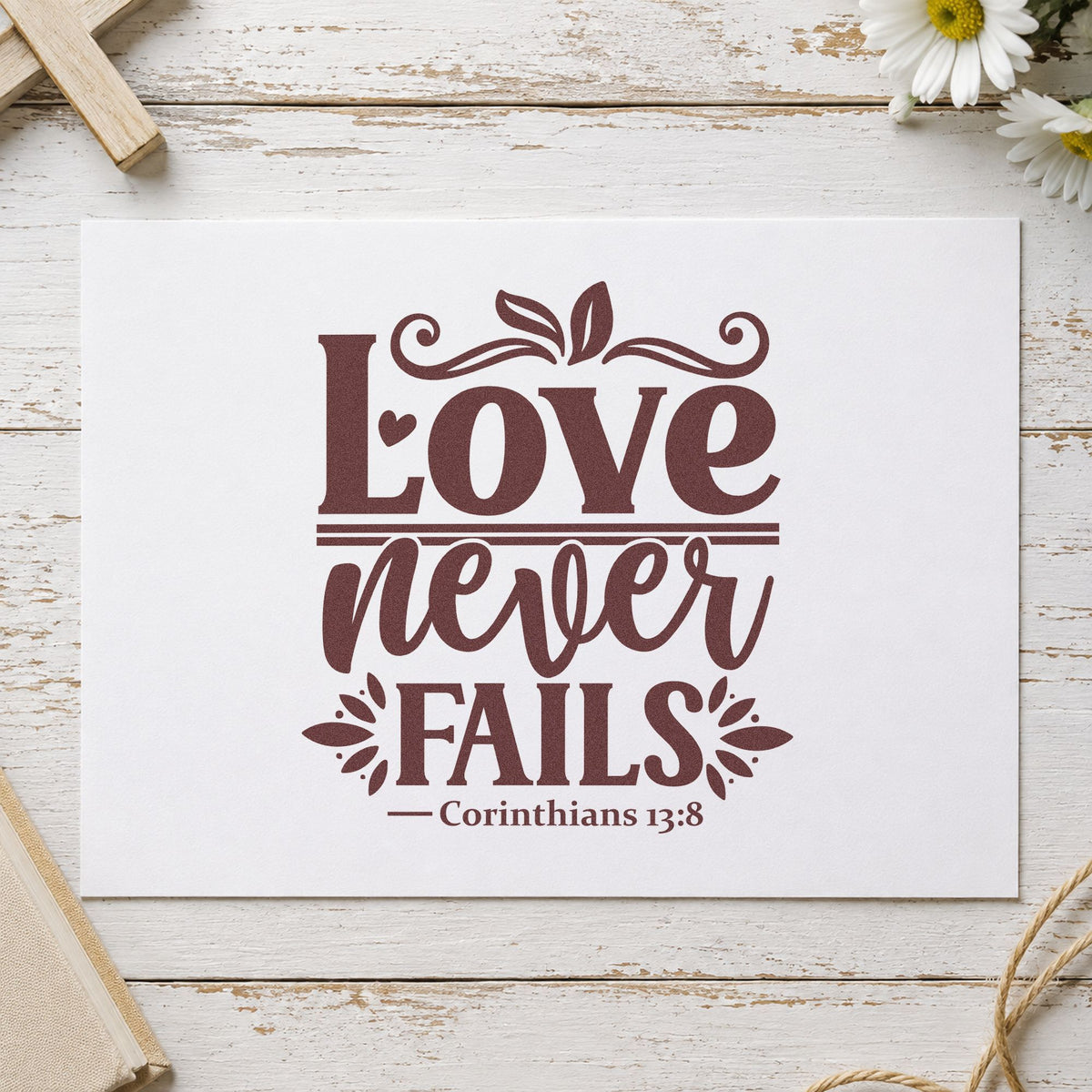Love Never Fails rubber stamp printed in brown ink, ready for couple scrapbooks and similar paper crafts.