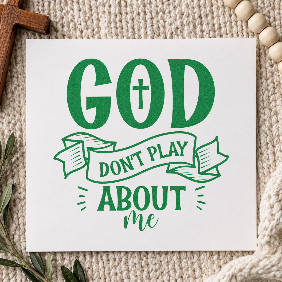 God Don't Play Ribbon craft stamp imprint in green ink on a handmade project, one idea being statement tees.