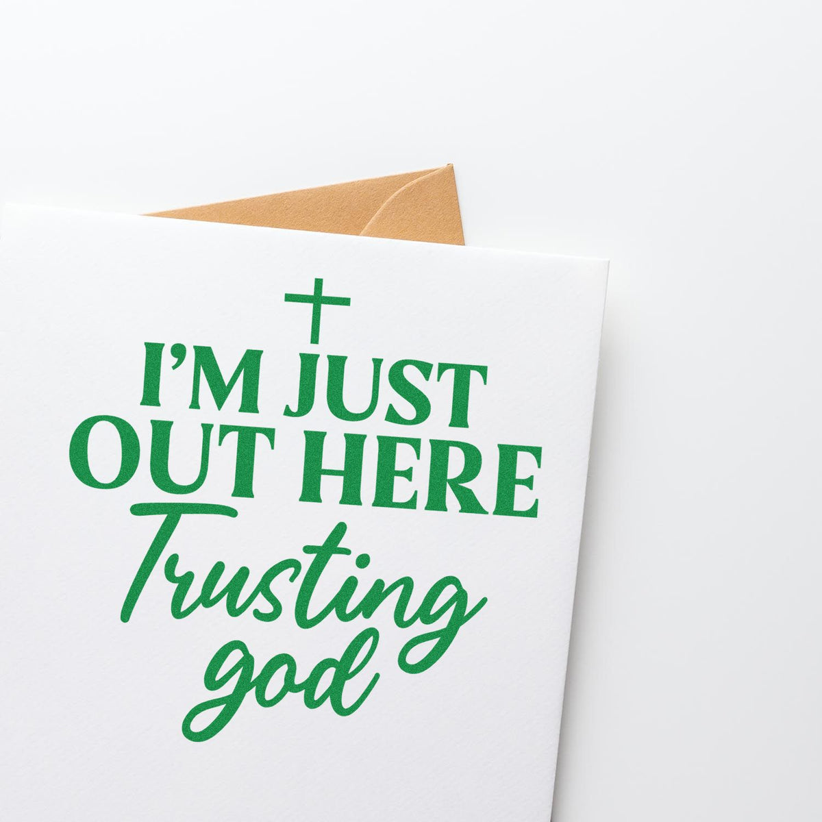 Out Here Trusting God rubber stamp shown in green ink, stamped for projects such as moving box labels.