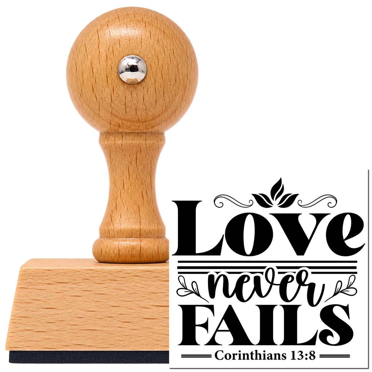 Love Never Fails Vintage Pro rubber stamp in European beech wood with a round knob handle, shown beside its black imprint.
