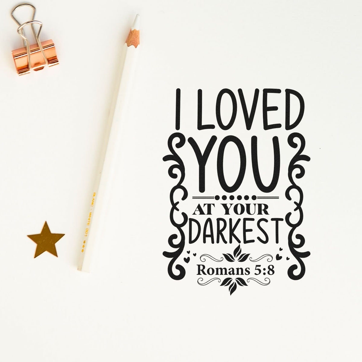 Loved At Your Darkest Scrolls Premium Wooden Stamp - Vintage Pro imprint stamped in black ink. Side scrolls and leafy details decorate "I loved you at your darkest," with Romans 5:8.