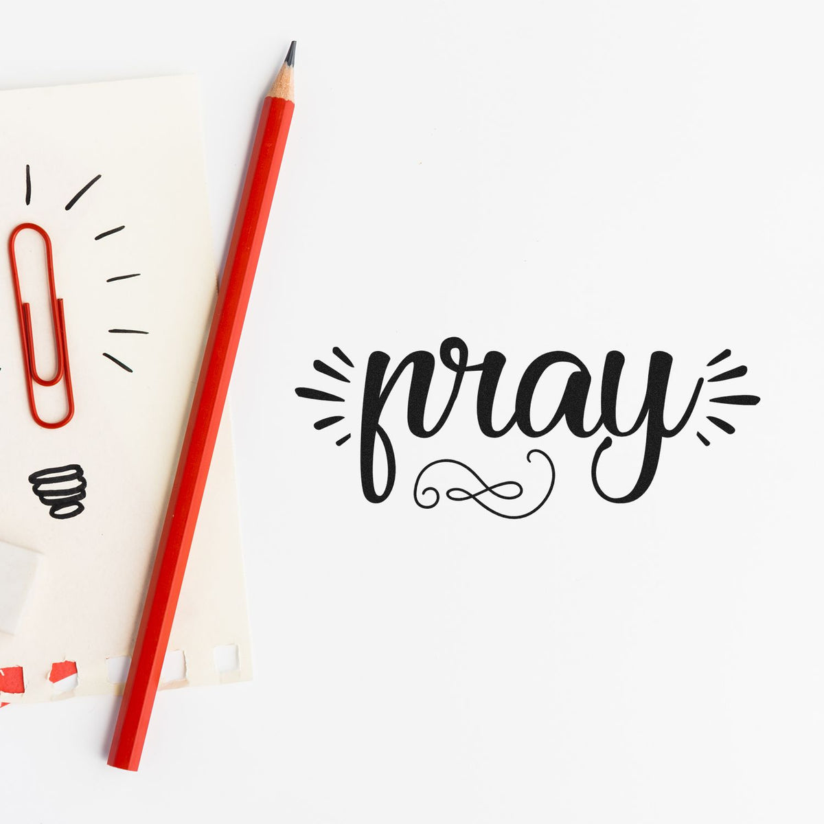 Pray Radiating Script Lettering Stamp - Premium Vintage Pro Wooden imprint stamped in black ink. Large "Pray" script is flanked by short radiating marks and a looped flourish underneath.
