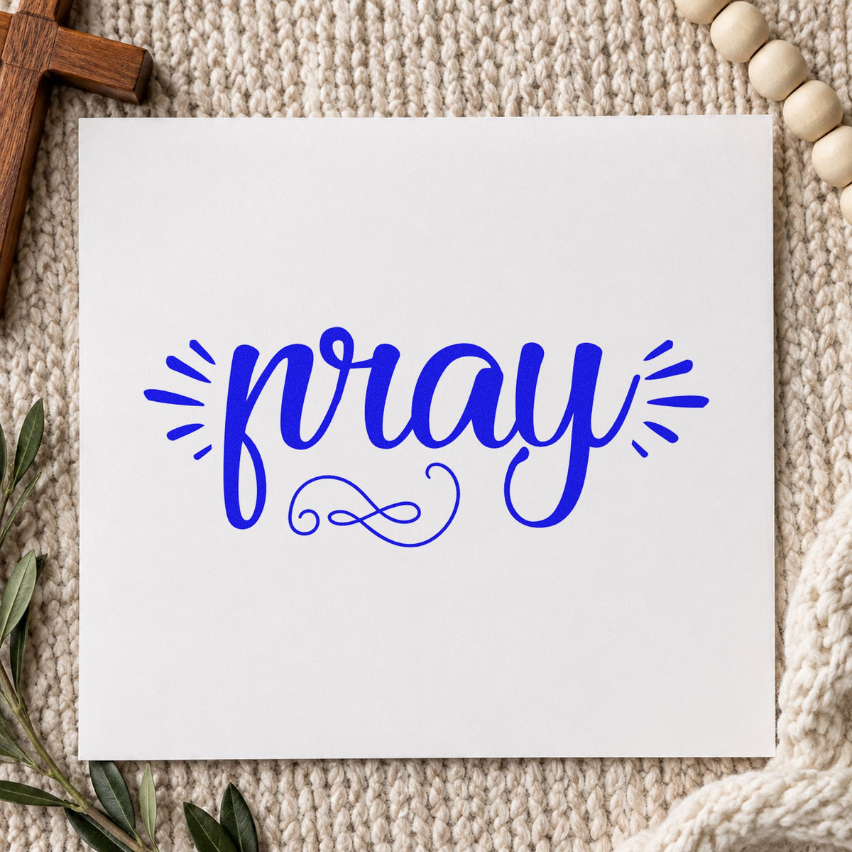 Pray Radiating Script craft stamp imprinted in blue ink on paper, a design suited to prayer box lids.