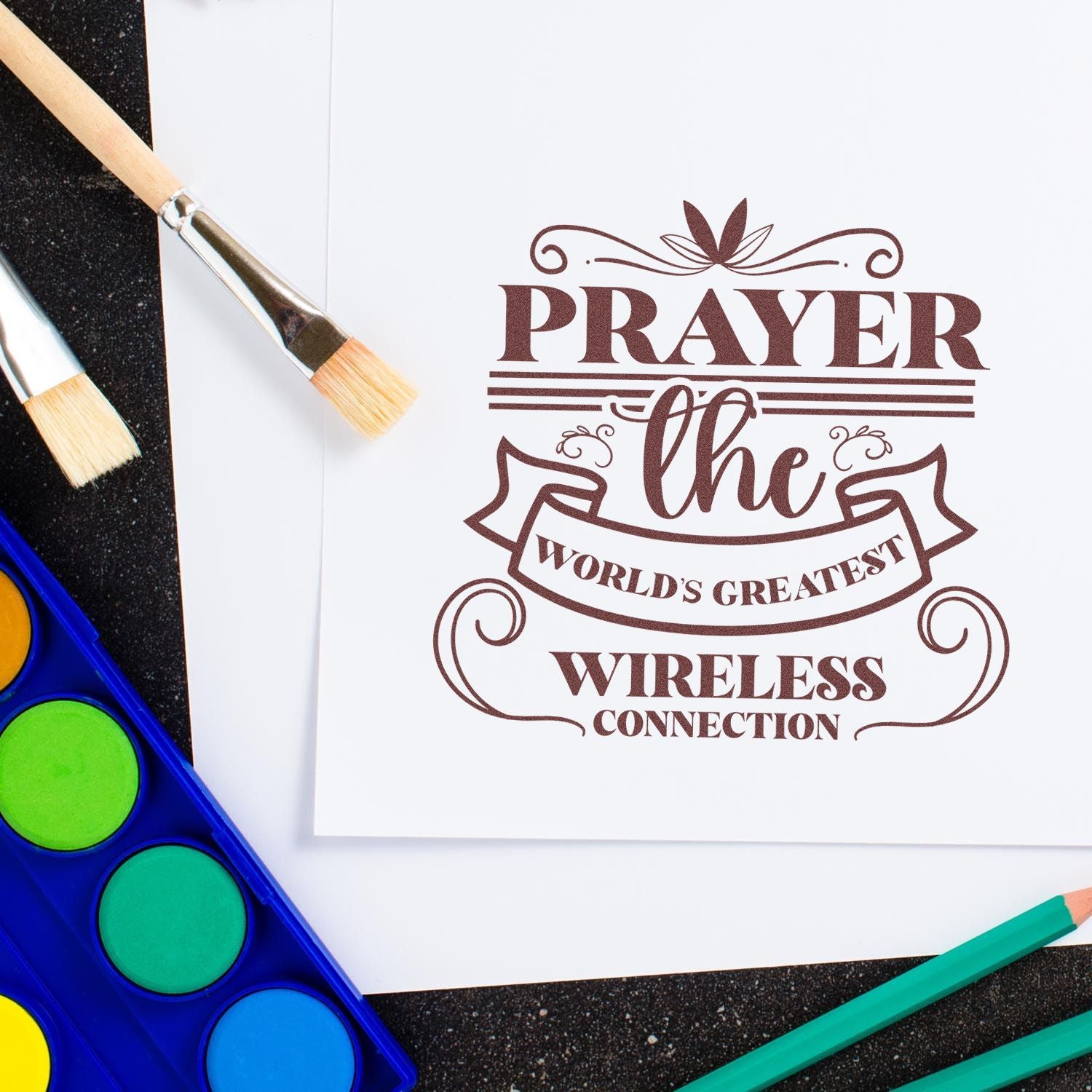 Prayer the World's Greatest Wireless Connection rubber stamp design with paintbrushes and watercolor supplies.