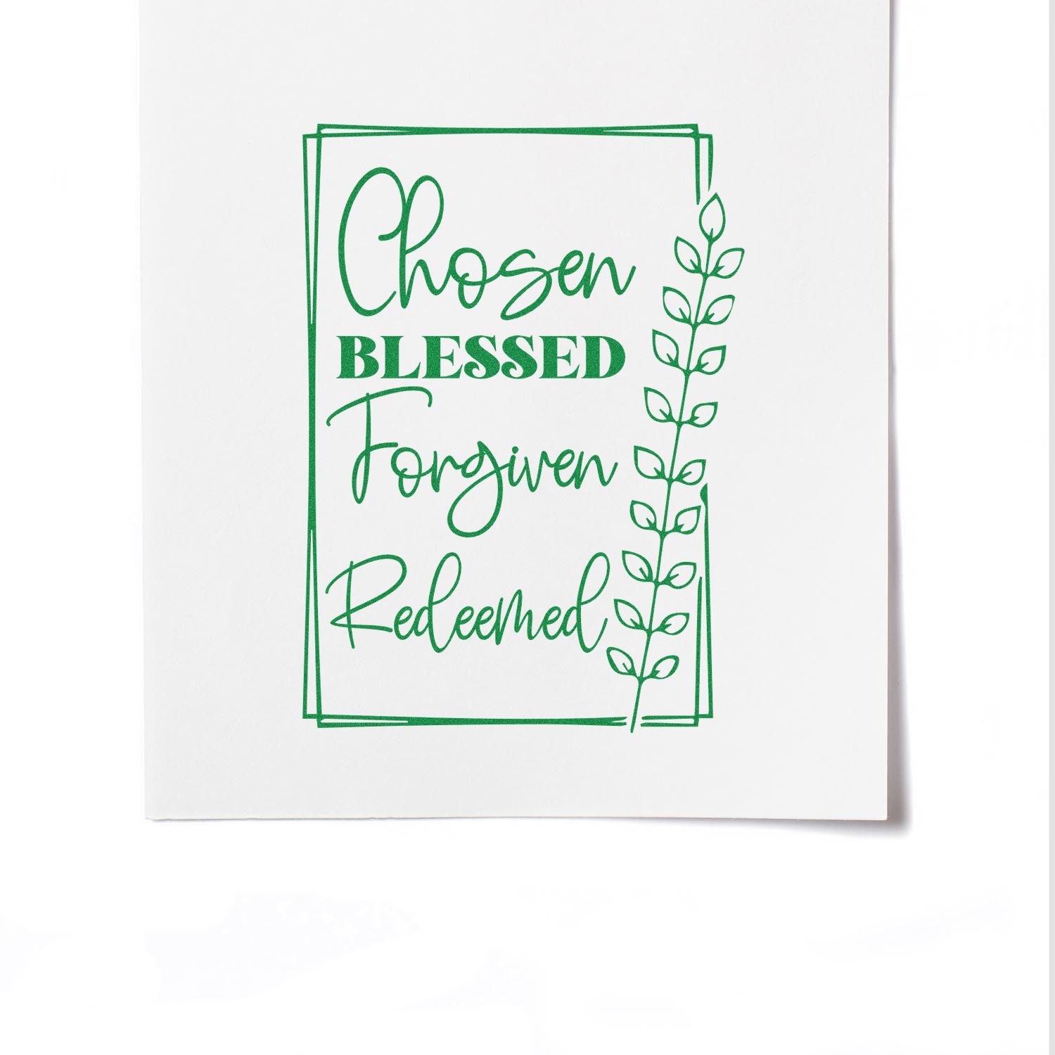 Green Christian rubber stamp impression reading Chosen Blessed Forgiven Redeemed with leafy border on white paper.
