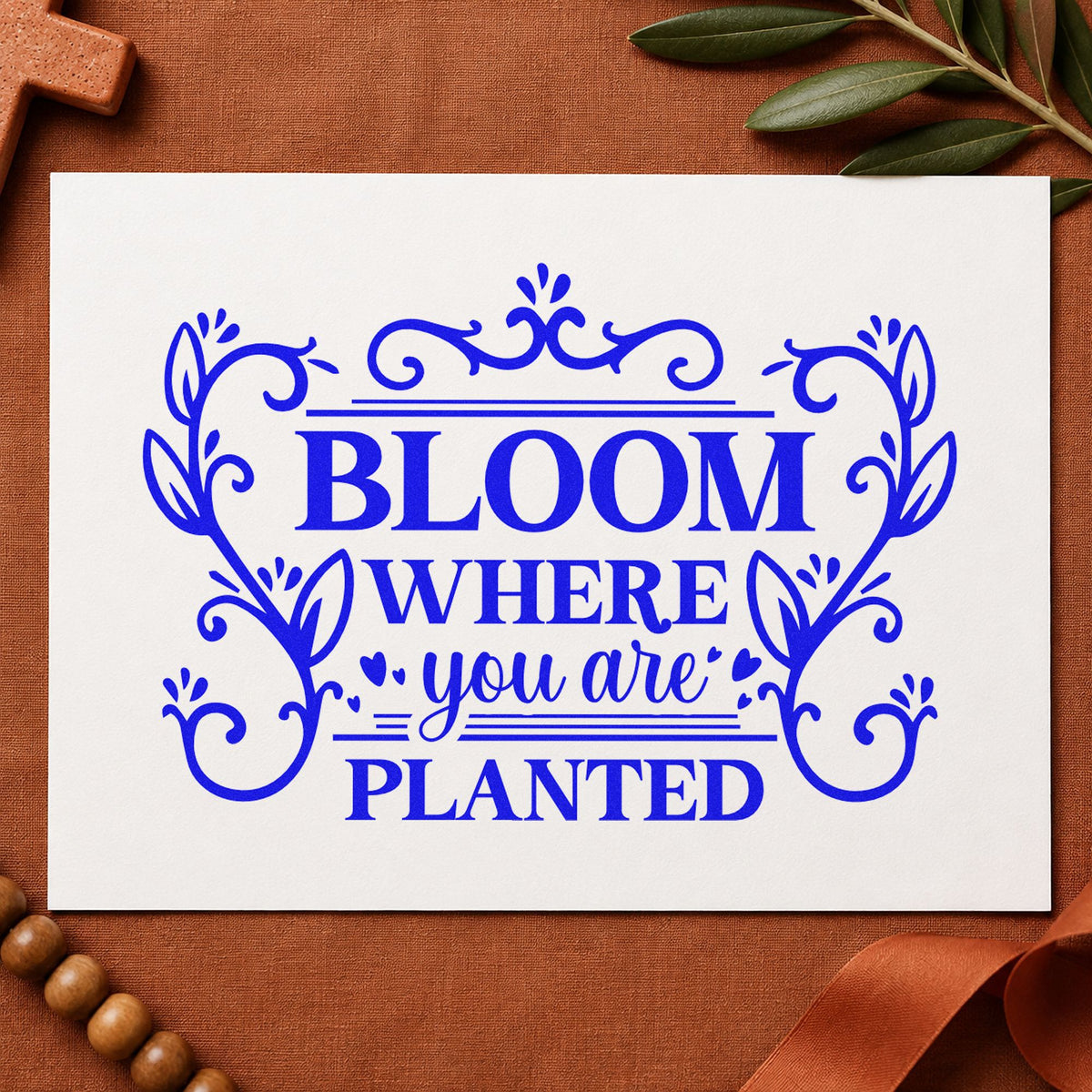 Bloom Where Planted Ornamental craft stamp imprinted in blue ink on paper, a design suited to seed packet gifts.