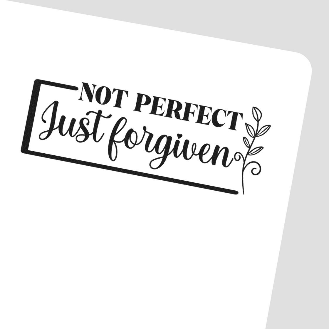 Not Perfect Forgiven Leaf Frame Premium Wooden Stamp - Vintage Pro imprint stamped in black ink. A small leafy sprig accents a rectangular "Not perfect, just forgiven" design.