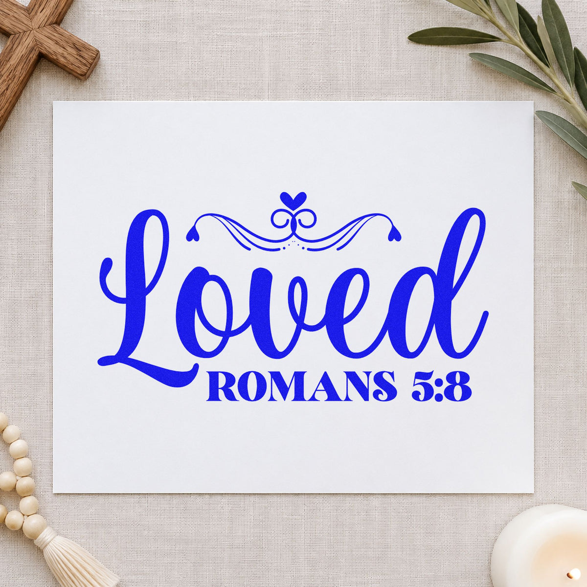 Loved Romans Five Eight craft stamp imprinted in blue ink on paper, a design suited to sympathy notes.