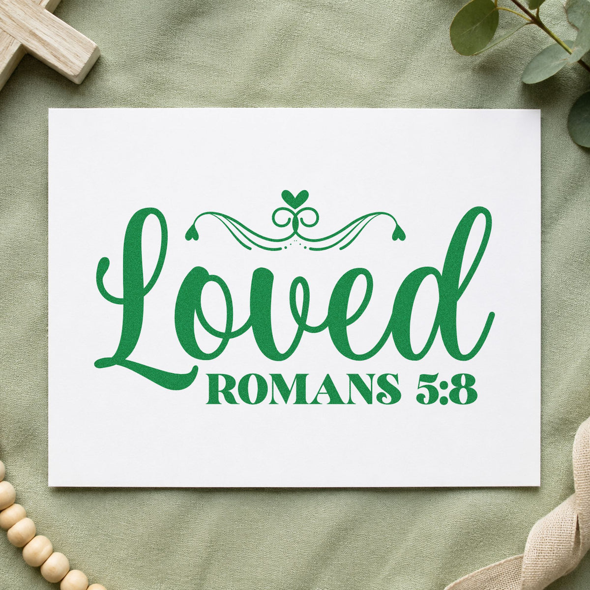 Loved Romans Five Eight craft stamp imprint in green ink on a handmade project, one idea being framed nursery art.